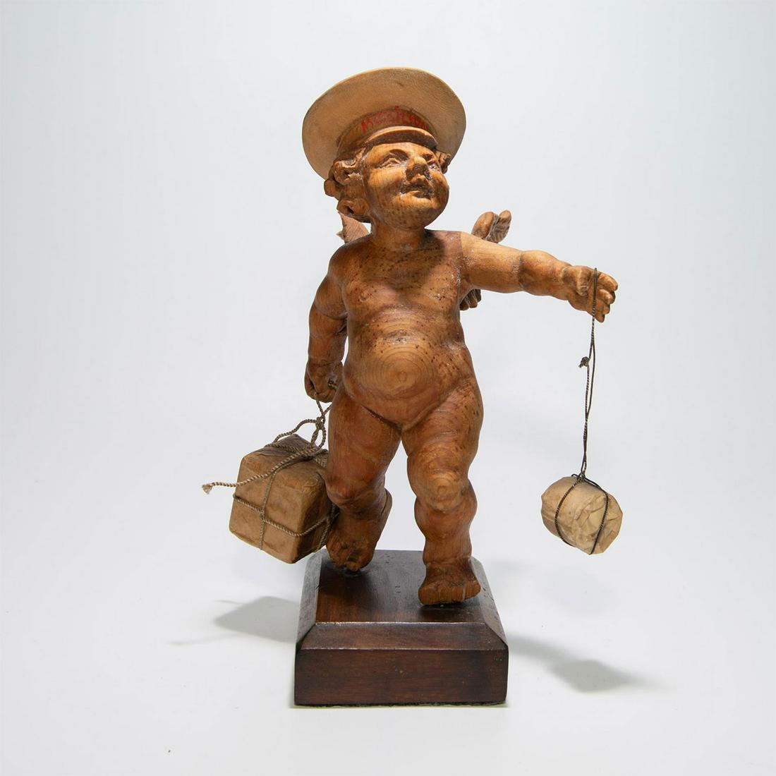 19TH CENTURY HAND CARVED WOODEN POSTMAN ANGEL: Italian German. Aesthetic Movement. Modeled with parcels. Issued: c. 1850 Dimensions: 8"H Country of Origin: South Tyrol