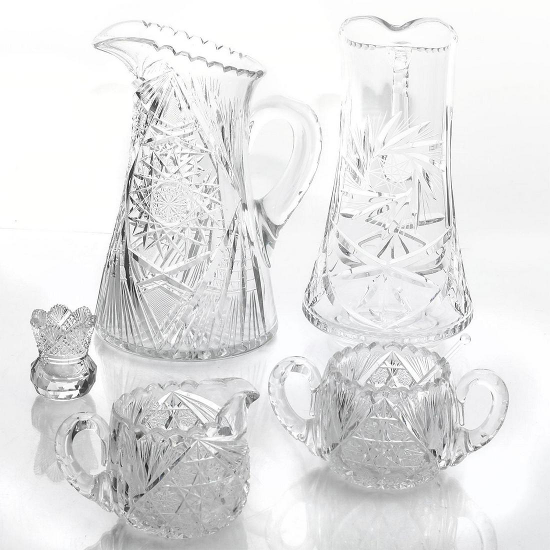 5 PIECE CUT CRYSTAL, BEVERAGE SERVING WARE: Two large pitchers, sugar bowl, creamer, salt cellar with spoon. Issued: 20th c. Dimensions: 11.5"H, tallest