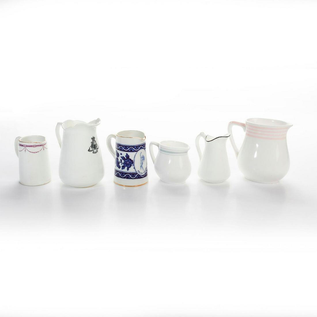 ROYAL DOULTON HOTEL ADVERTISING WARE MINI PITCHERS: Various advertisements. Royal Doulton backstamp on bottom. Ritz Hotel, Felix Hotel, Savoy Hotel x2, and Waldorf Hotel. Issued: 20th c. Dimensions: 4"H, tallest Manufacturer: Royal Doulton Country of O