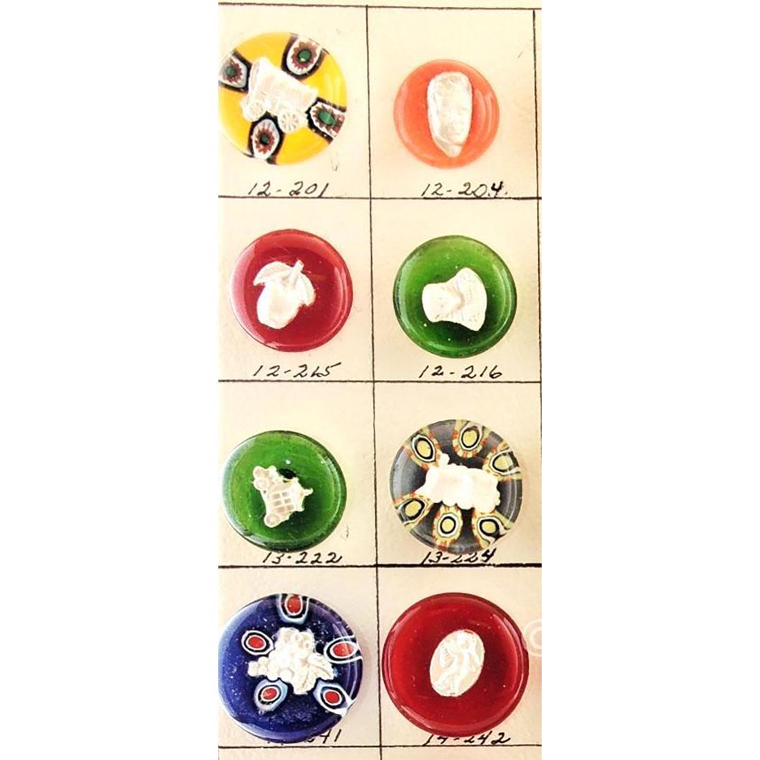 8 MODERN ARTIST PAPERWEIGHT BUTTONS: Small card of 8 Sulphide Paperweight buttons All made by Theresa Rarig. Several depicting transportation such as a covered wagon, a train engine, a car and others. Nice color assortment.