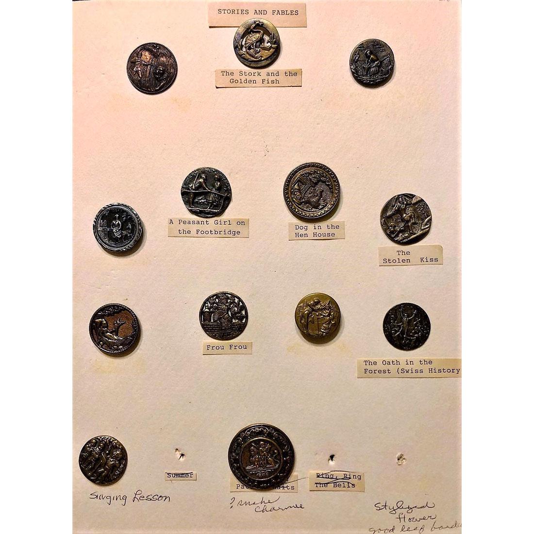 2 CARDS OF DIVISION 1 METAL PICTURE BUTTONS: 31 S/M/L metal picture buttons on 2 cards. This lot includes a copper Teddy Roosevelt shooting the lion, a brass St. Cecelia at the Organ, a brass button of the Singing Lesson, a medium Ivoroid of Flo