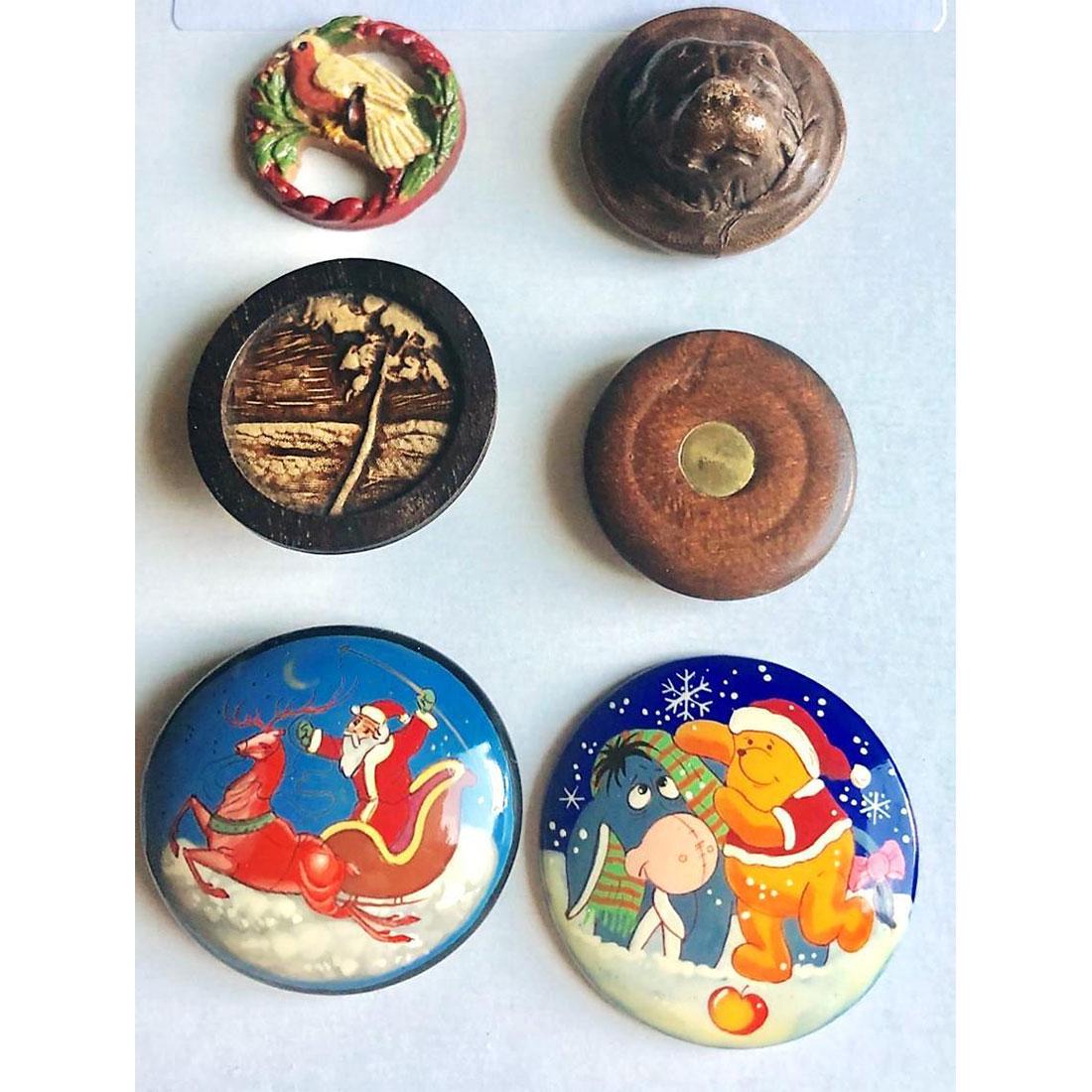 SMALL CARD OF DIVISION ONE AND THREE WOOD BUTTONS: 5 Medium/Large assorted wood buttons plus 1 large leather. The lot includes a multi colored pierced Burwood bird, a high relief molded leather animal, head, a low relief molded leather scene set in wo