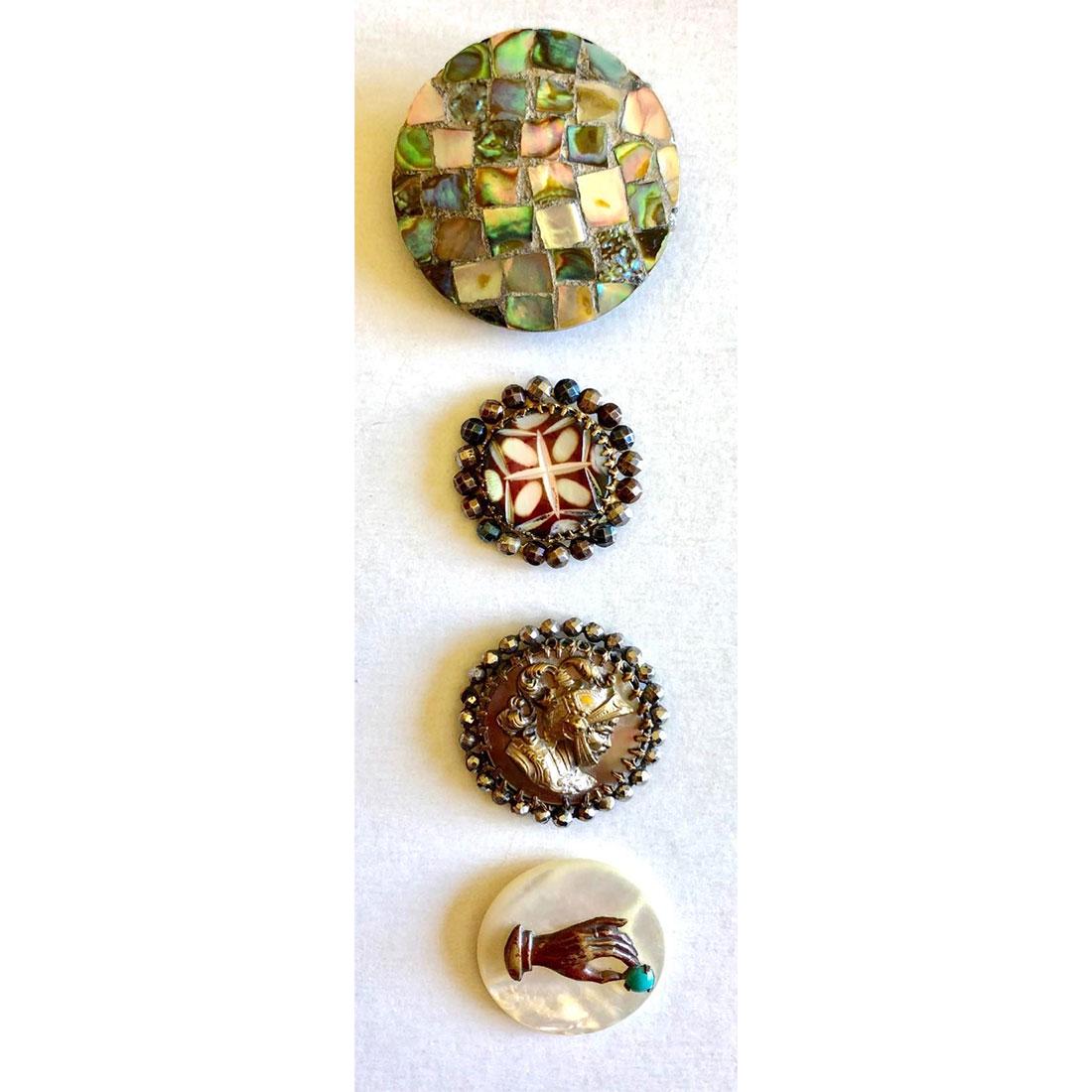SMALL CARD OF ASSORTED PEAR BUTTONS INCLUDING LAMINATED: 4 Medium/Large pearl buttons including laminated. These include a medium brass escutcheon of a hand pinching a turquoise blue glass bead, a dyed and carved pattern in metal with a steel border, anothe