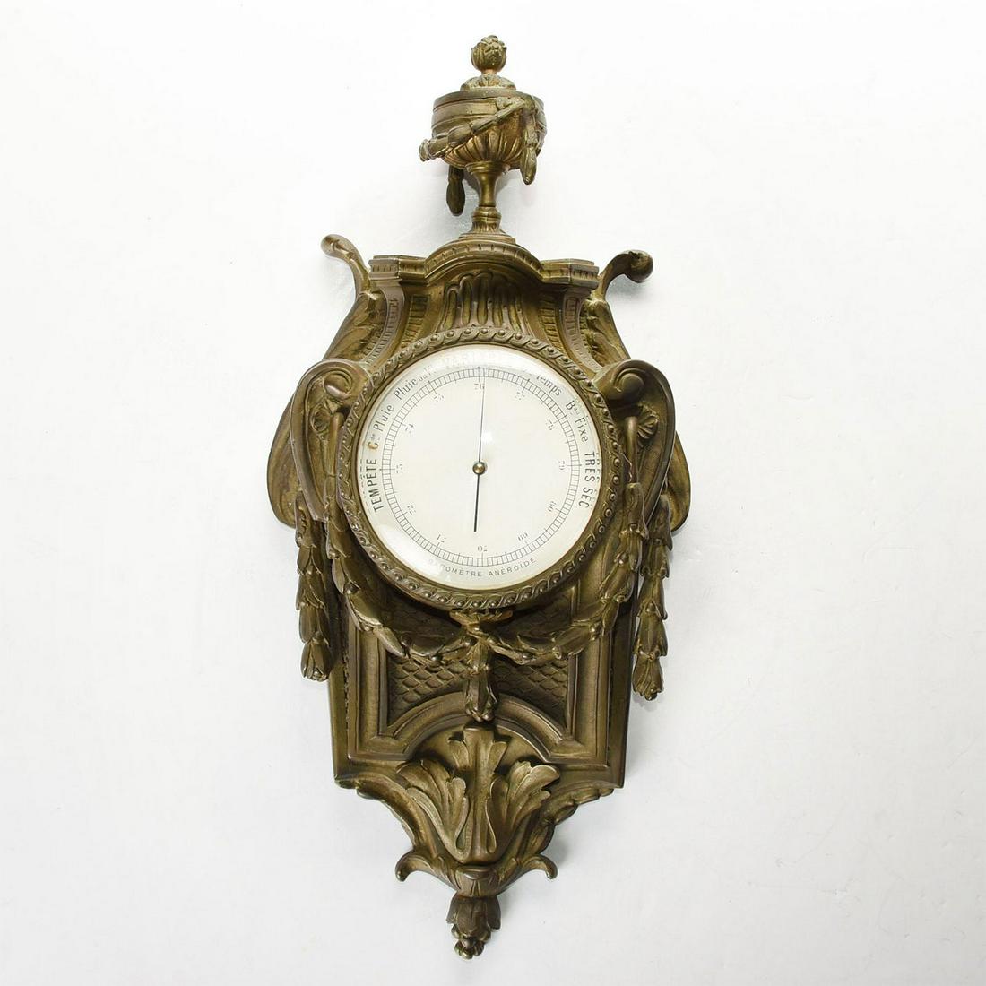 FRENCH ART NOUVEAU BRONZE WALL MOUNTED BAROMETER: Neoclassical decor. Glass covered face. Ornamental floral motifs. A 19th century Neoclassical barometer, crafted in richly patinated bronze. Floral and other Art Nouveau motifs, including leaves and b