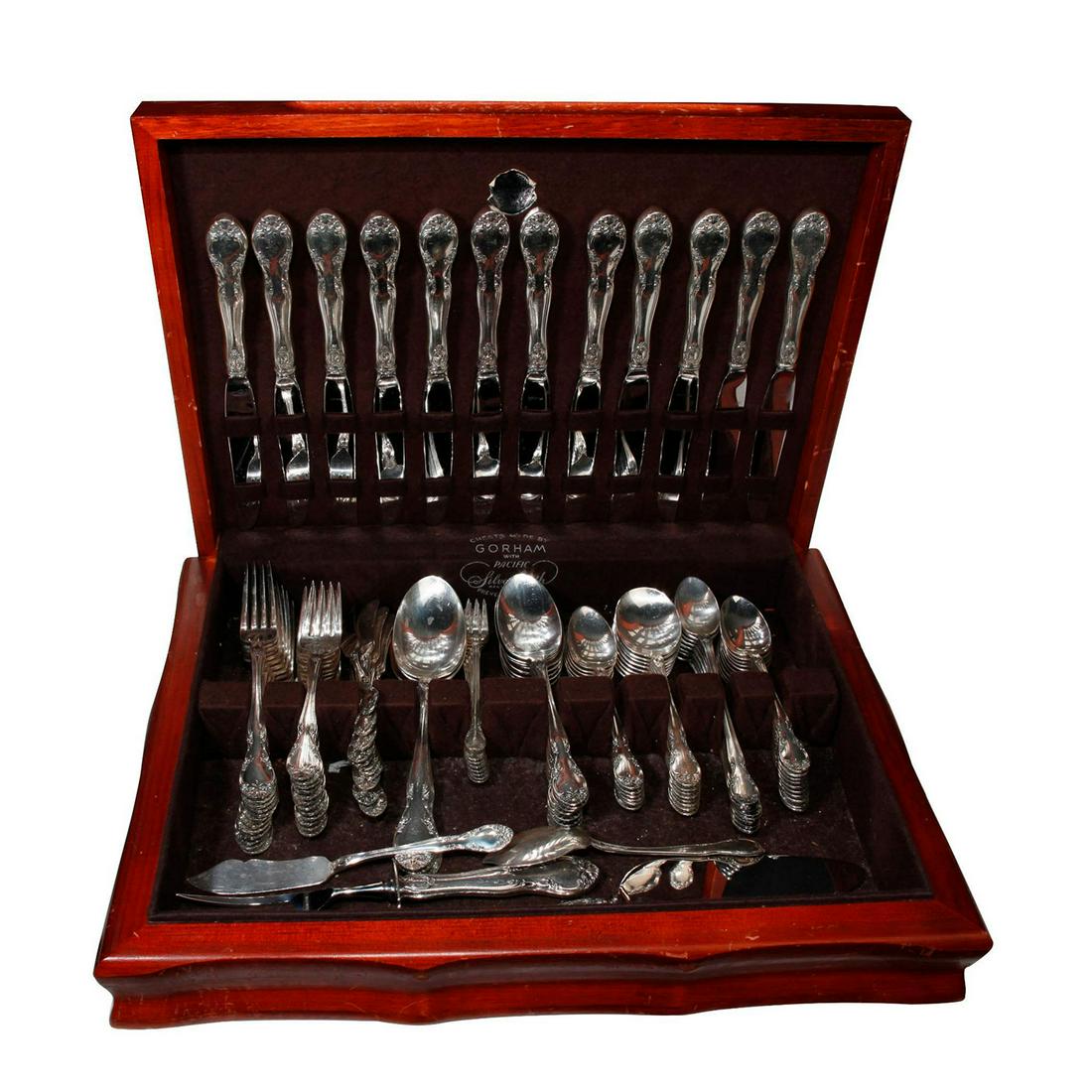 112 PIECE SET GORHAM SILVERWARE W. CASE: Assorted forks, spoons, knives, New Elegance pattern. EPNS. Case has storage ware, dinting, and scratches. Issued: 20th c. Dimensions: 17"L x 12"W, case Manufacturer: Gorham Country of Origin: USA