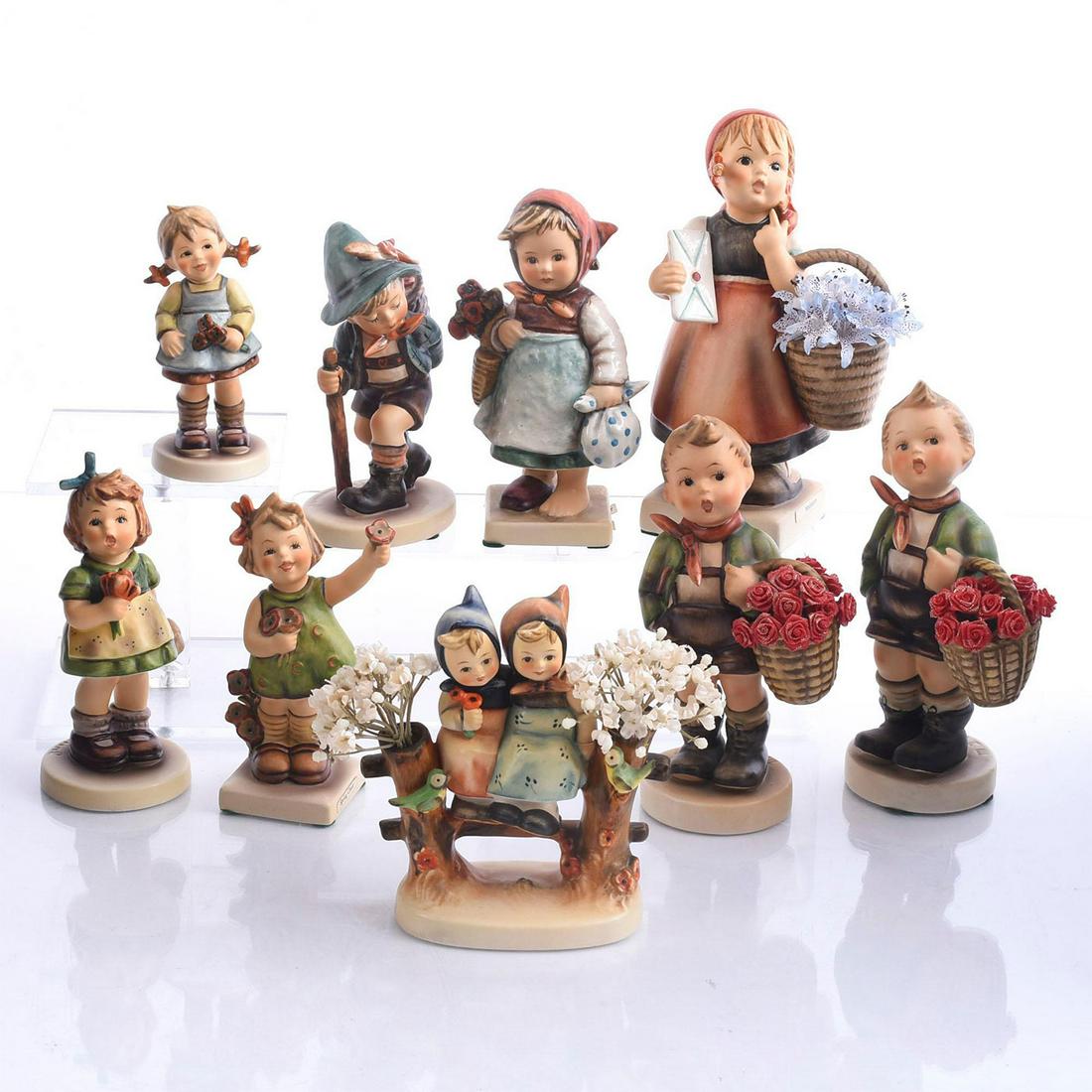 9 GOEBEL HUMMEL FIGURINES, CHILDREN & FLOWERS: Bisque porcelain children studies modeled with flora. Produced by Goebel for Hummel, the most widely collected figurines of the 20th century. Nine child studies, modeled in a variety of adorable situa