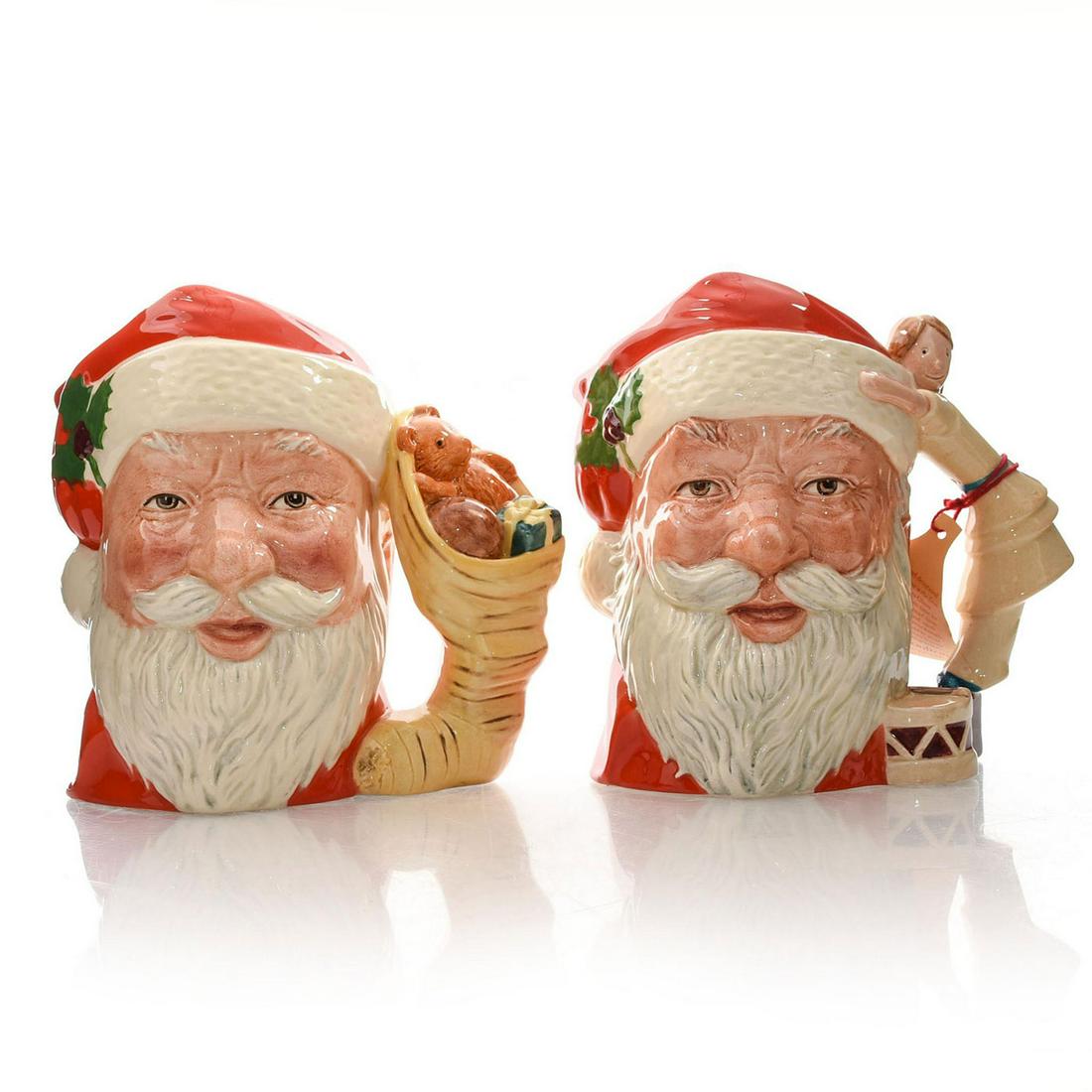 2 ROYAL DOULTON LG CHARACTER JUGS, SANTA CLAUS: D6668 doll drum handle. D6690 toys handle. Stamped ROYAL DOULTON. Two Royal Doulton Santa Claus character jugs with handle variations. D6668, 1981, D6690 1983,Â Artist: Michael Abberley Issued: 20t