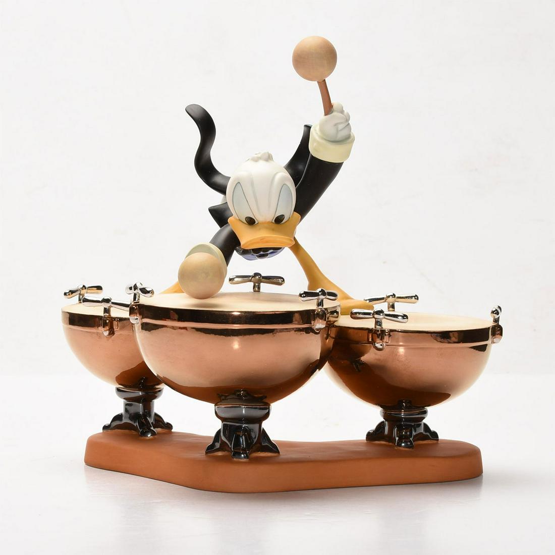 DISNEY CLASSICS SYMPHONY HOUR FIGURE, DONALDS DRUM BEAT: Donald Duck modeled with orchestral drums. DISNEY backstamp. Stamped to base WALT DISNEY CLASSICS COLLECTION SYMPHONY HOUR DONALD'S DRUM BEAT. Collectors box. Certificate of Authenticity. Issued: c. 1