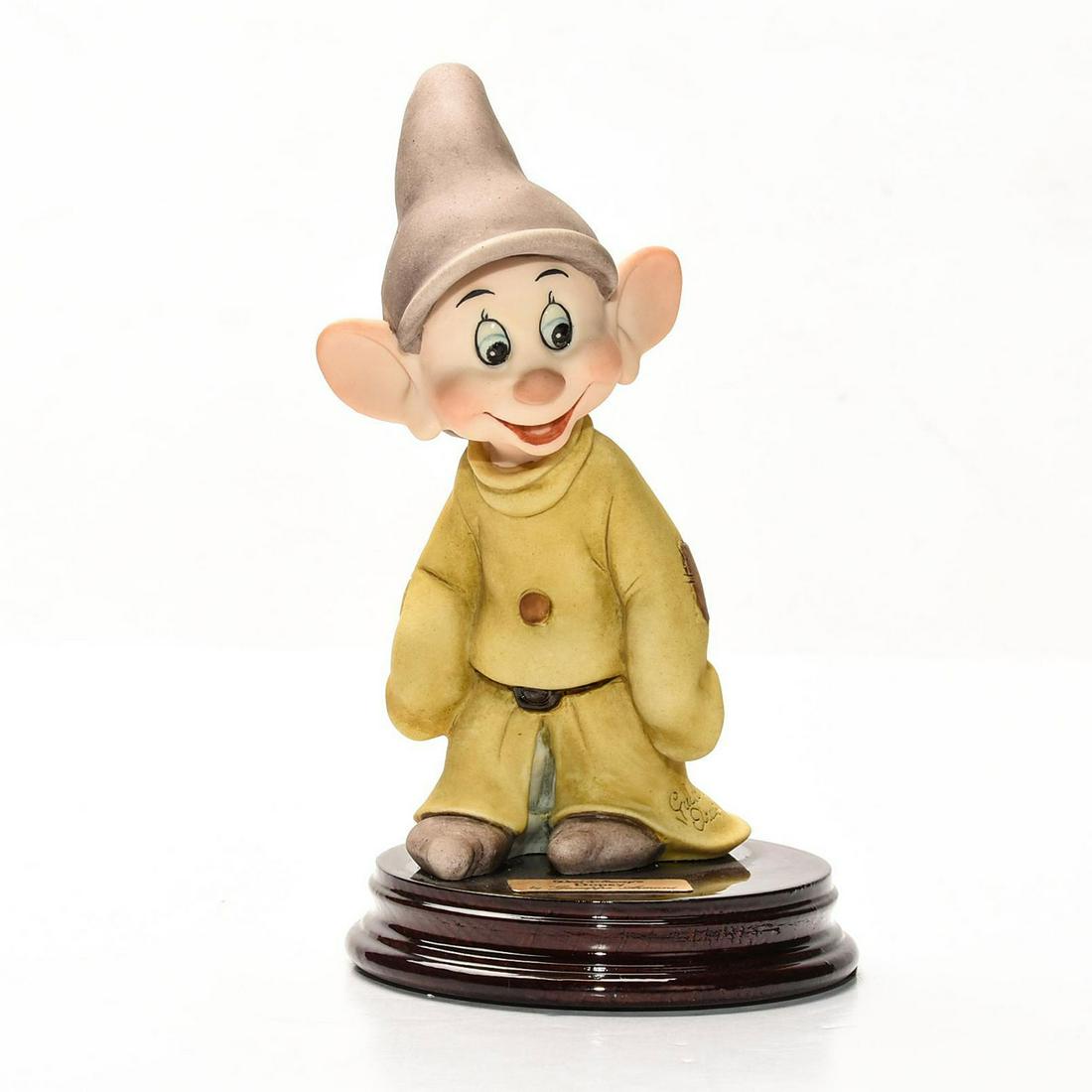 DISNEY GIUSEPPE ARMANI SNOW WHITE FIGURINE, DOPEY: Artist signed, presented on decorative wooden base. DISNEY stamp. A Walt Disney special edition sculpture by Italian artist Giuseppe Armani (1935-2006) depicting an exquisitely detailed scene from the