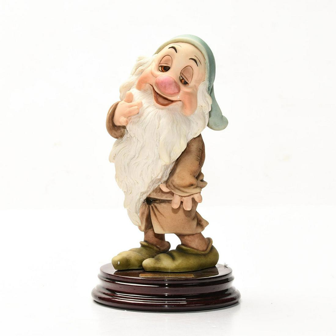 DISNEY GIUSEPPE ARMANI SNOW WHITE FIGURINE, SLEEPY: Artist signed, presented on decorative wooden base. DISNEY stamp. A Walt Disney special edition sculpture by Italian artist Giuseppe Armani (1935-2006) depicting an exquisitely detailed scene from the