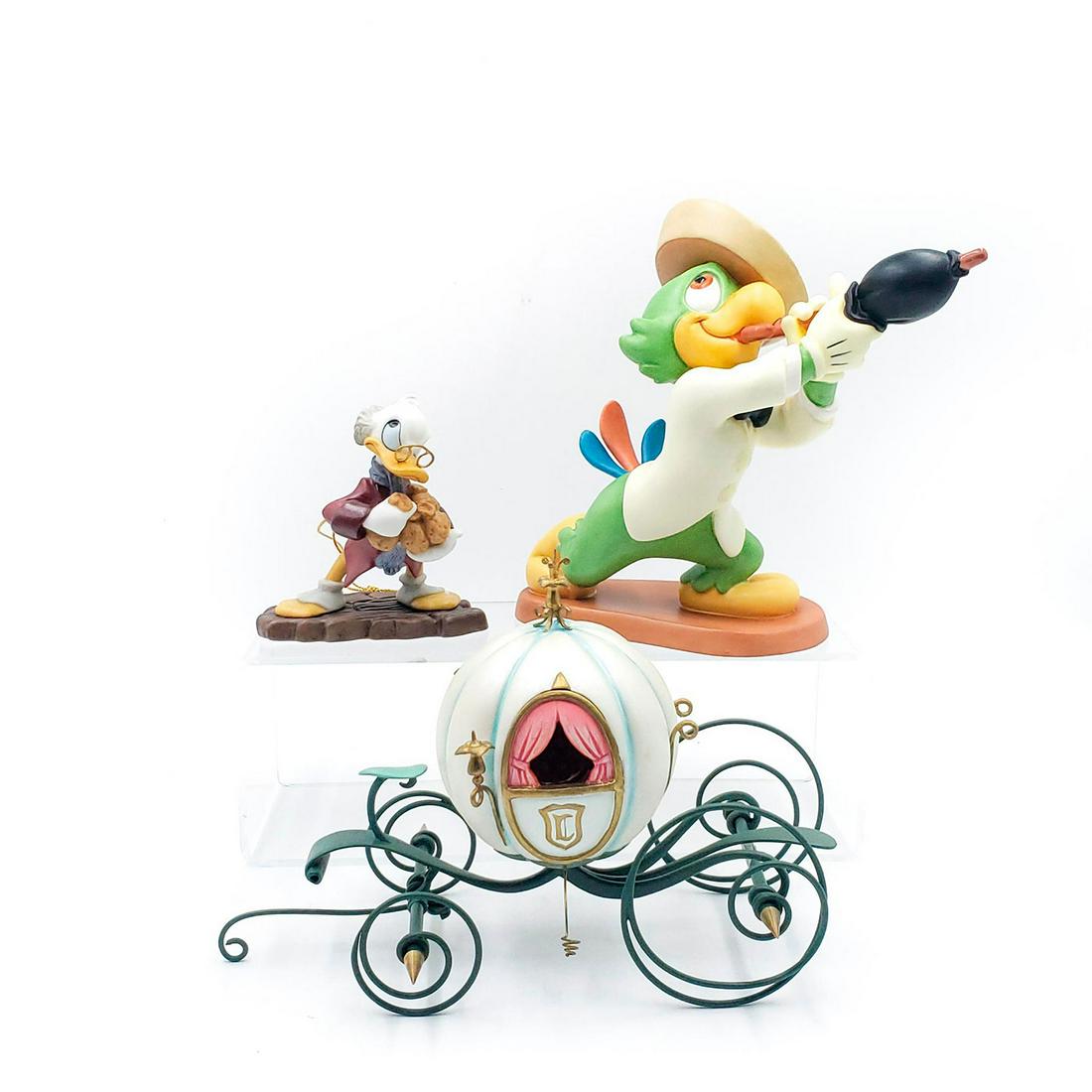 3 WALT DISNEY CLASSICS FIGURINES: Scrooge McDuck, Cinderella's coach, Amigo Jose. In original packaging, with Certificates of Authenticity. Issued: 1990s Dimensions: 11.5"L x 8"H x 8"W, largest box Manufacturer: Walt Disney Co.