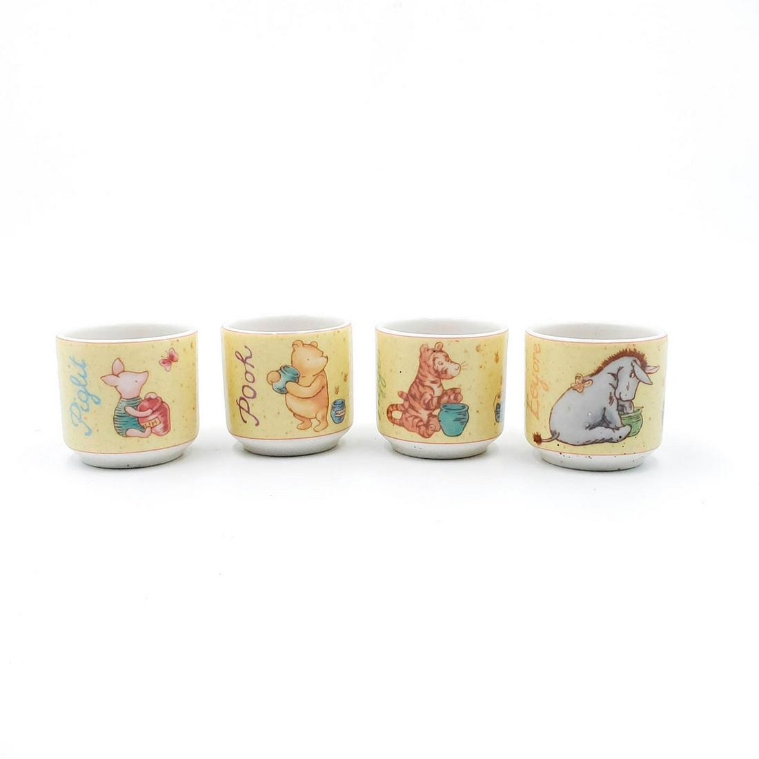 ROYAL DOULTON CLASSIC POOH GIFT COLLECTION, EGG CUPS: Piglet, Tigger, Pooh, Eeyore egg cups. Doulton backstamp. Issued: 20th c. Dimensions: 9"W Manufacturer: Royal Doulton Country of Origin: England