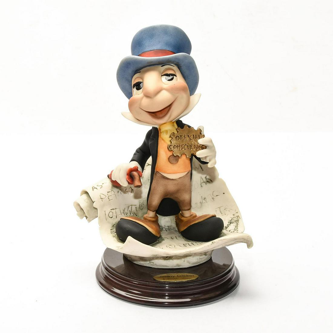 DISNEY GIUSEPPE ARMANI PINOCCHIO FIGURE, JIMINY CRICKET: Artist signed, presented on decorative wooden base. DISNEY stamp. A Walt Disney special edition sculpture by Italian artist Giuseppe Armani (1935-2006) depicting an exquisitely detailed scene from the