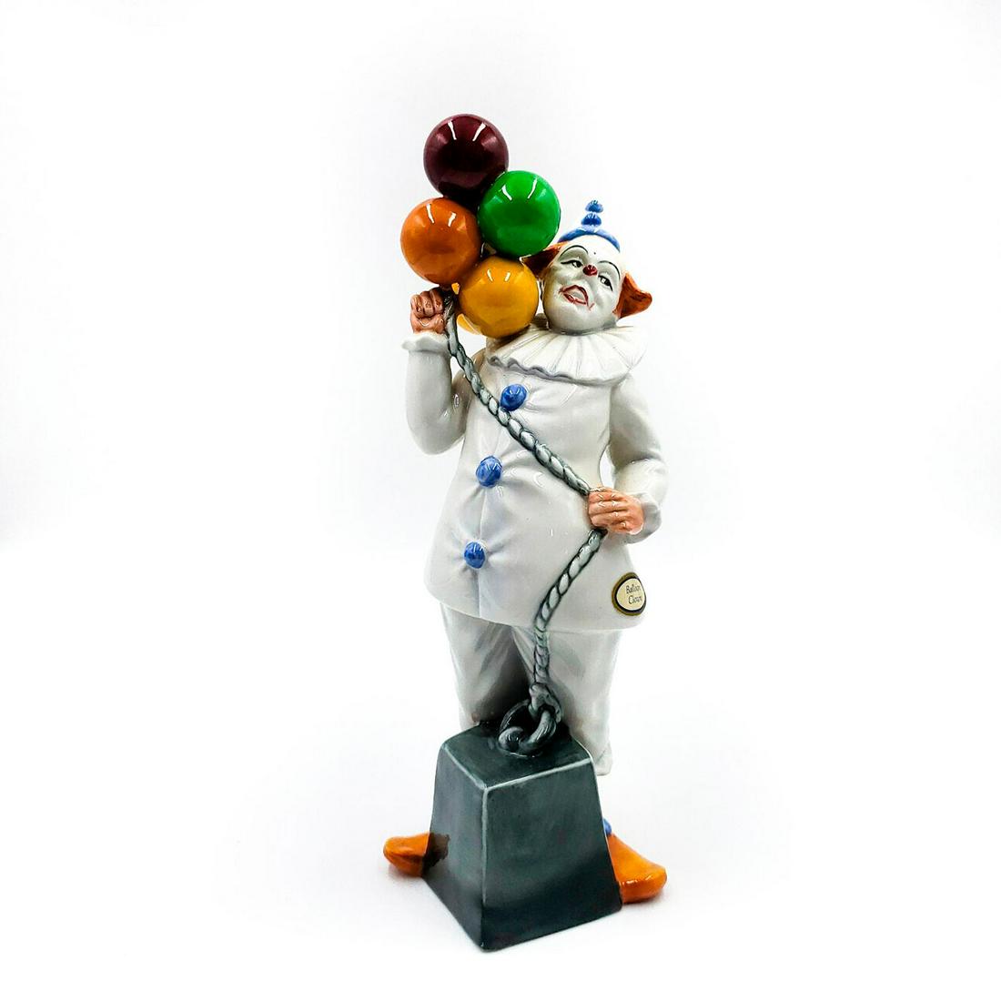 ROYAL DOULTON FIGURINE, BALLOON CLOWN HN2894: White and blue. Stamped Royal Doulton on underside. Artist: W. Harper Issued: 1986-1992 Dimensions: 9.25"H Manufacturer: Royal Doulton Country of Origin: England