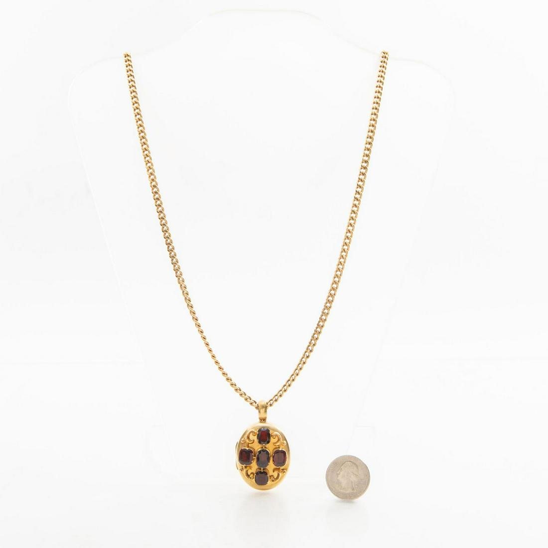 VICTORIAN JEWELRY GOLD AND GARNET LOCKET AND CHAIN: 14 karat gold. 5 amethysts. Total weight approx. 45 grams. Designed with five exemplary garnet stones in a cross design. 14 karat gold. Contains two Victorian photographs within. Very light scratches.