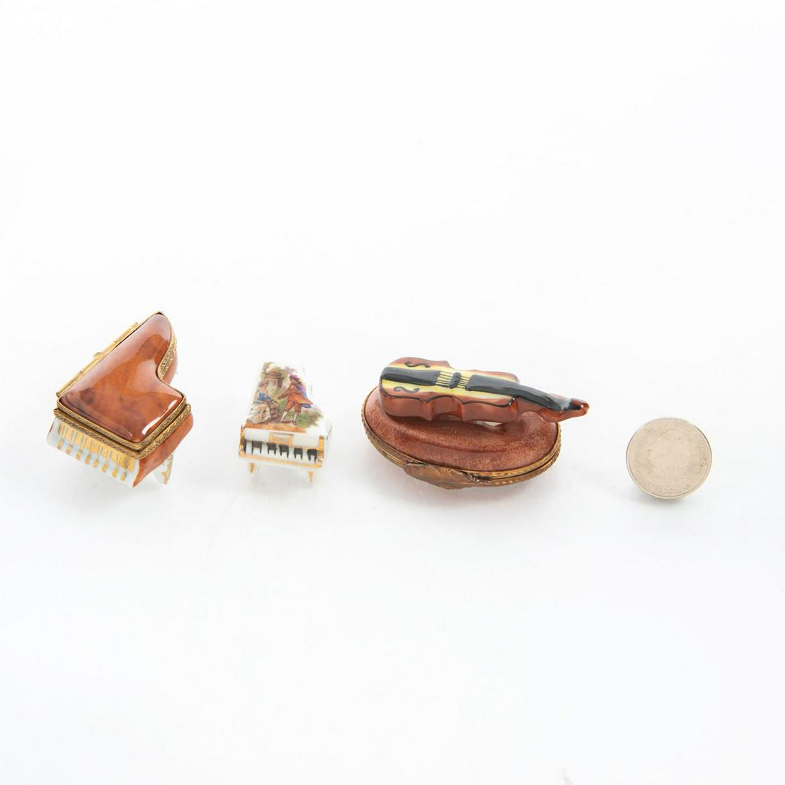 3 MUSIC THEMED LIMOGE BOXES: Two pianos, one violin. Marked Limoges, France to bottom. Hand painted porcelain miniatures. Issued: 20th c. Dimensions: 2.5"L, longest Country of Origin: France