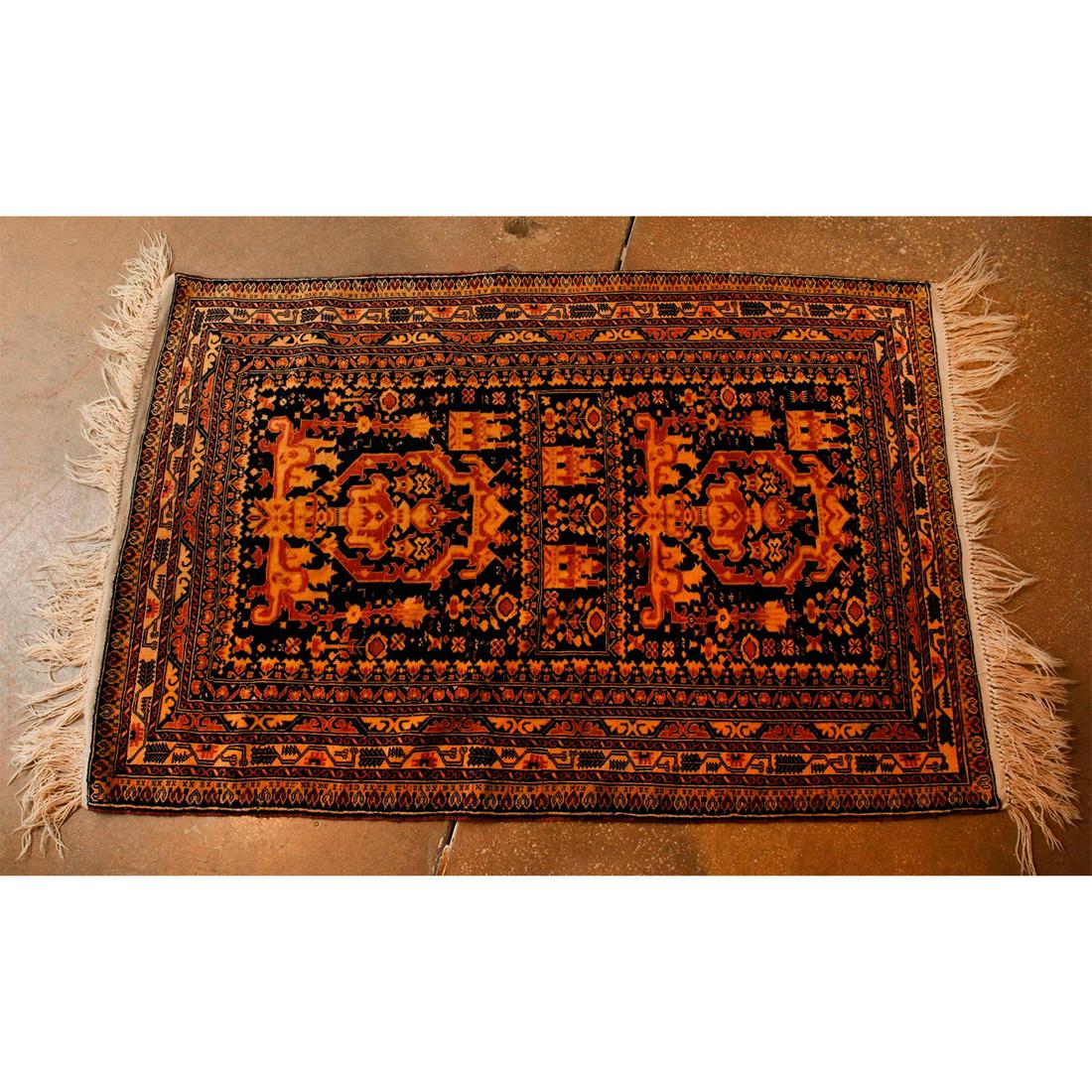 WOVEN AREA RUG: Patterned in navy blue, orange, and red colors. Issued: 20th c. Dimensions: 54"L x 36"W