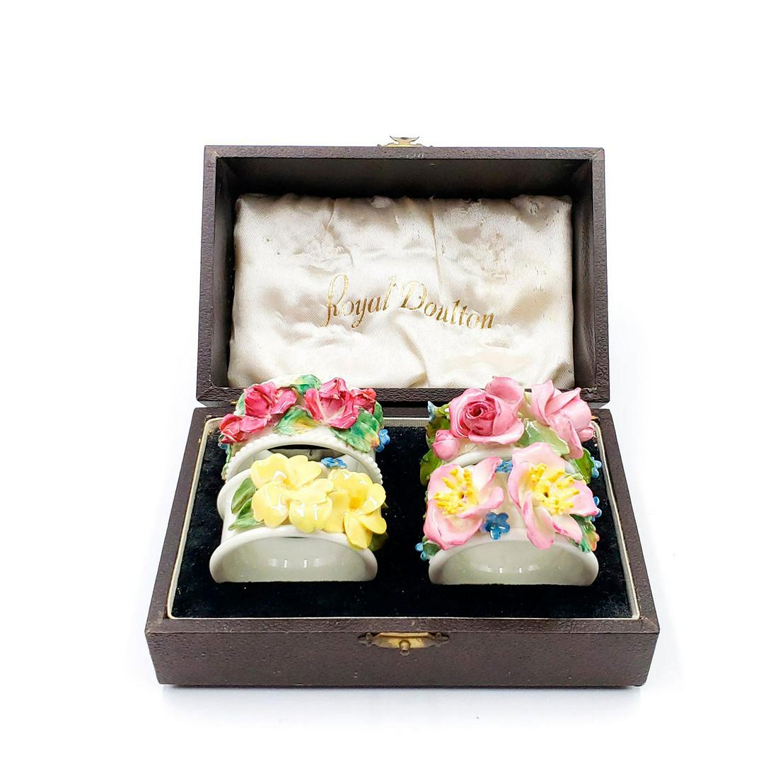 ROYAL DOULTON SET OF NAPKIN RINGS WITH CASE: Bone china hand decorated Floral reticulated ceramics. Doulton backstamp. Issued: 20th c. Dimensions: 4"W, largest Manufacturer: Royal Doulton Country of Origin: England