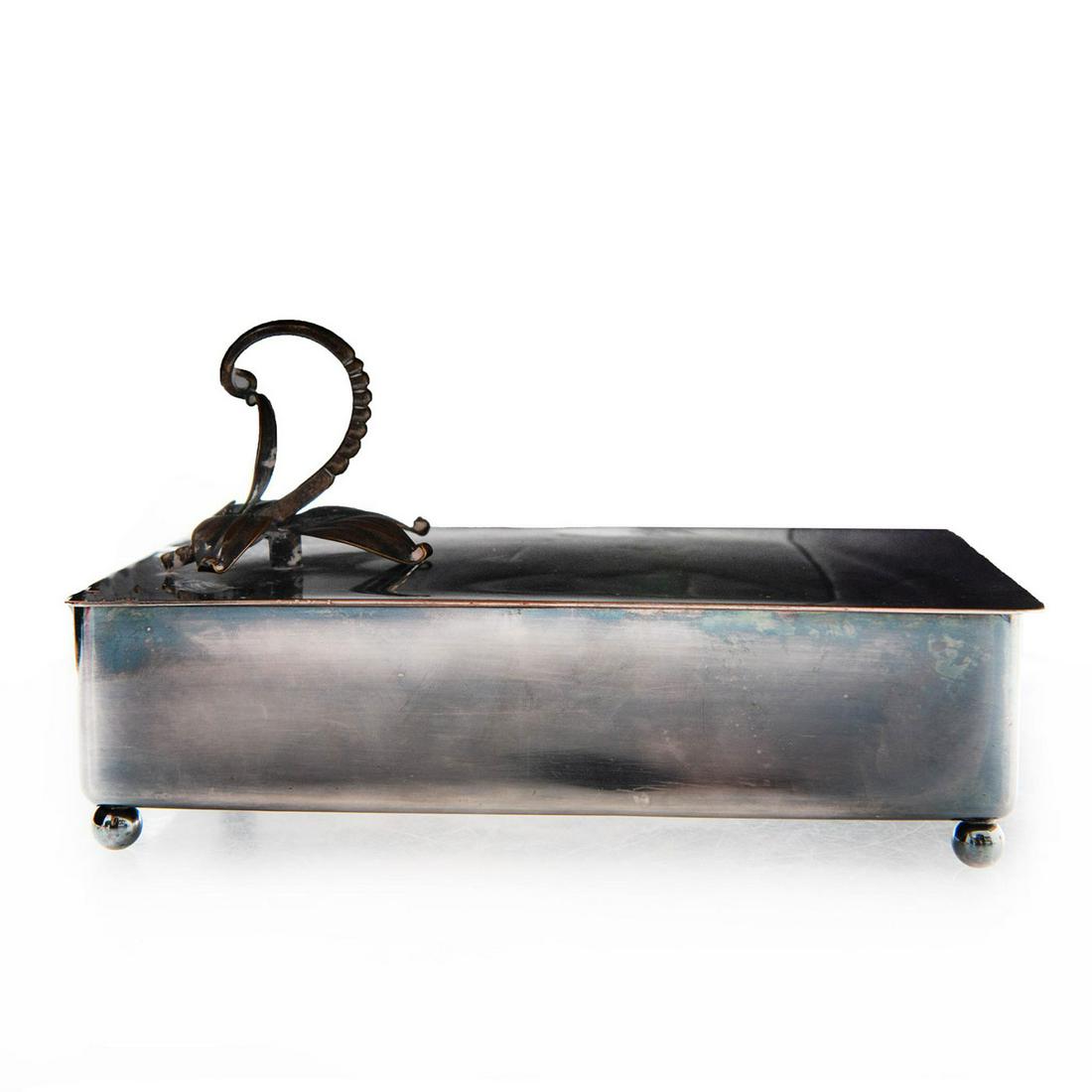 ROYAL HICKMAN SILVERPLATE BOX: Lily flower handle, stamped Royal Hickman with 3 crowns. Exquisite minimalist art deco design. Issued: 20th c. Dimensions: 7"L x 5"W x 4"H, to top of handle Manufacturer: Royal Hickman Country of Orig
