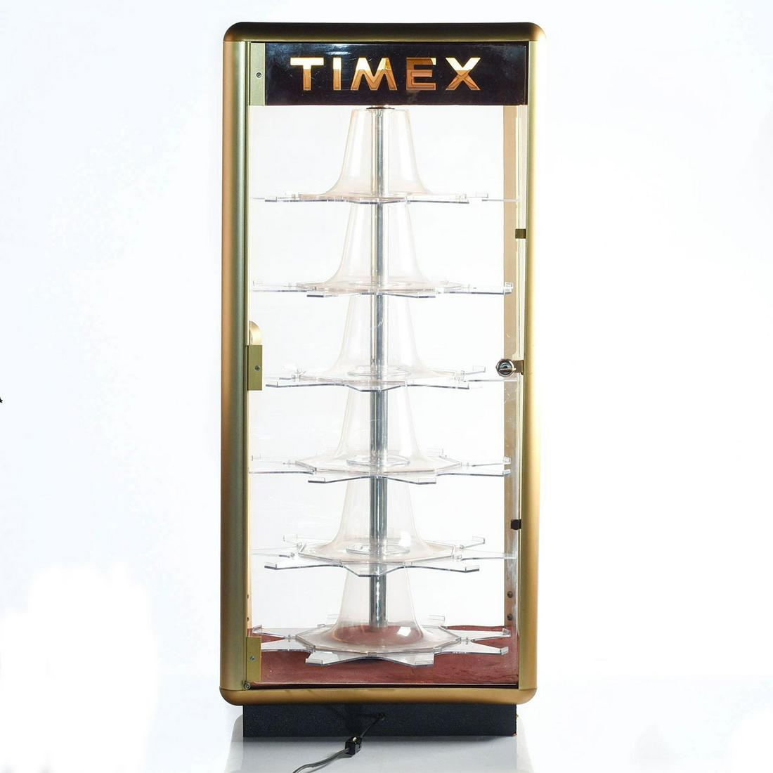 TIMEX WATCH ILLUMINATED ROTATING DISPLAY CASE: Case displays 48 watches. Includes key for lock. Case is tested functional, motor rotates the interior display stand and the light illuminates the case. Age related wear to felt. Issued: 20th c. Dimen