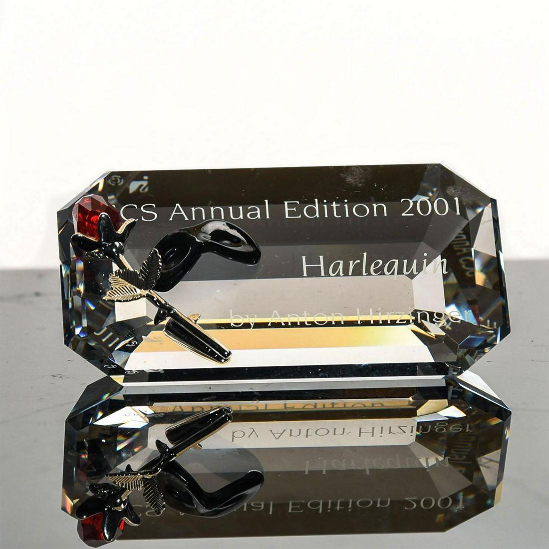 SWAROVSKI CRYSTAL HARLEQUIN PLAQUE, 2001: SCS Annual Edition. Features a rose and black mask. 2.5"L. Complete with original box. Artist: Anton Hirzinger Issued: 2001 Dimensions: 4.5"L x 6.5"W, box Manufacturer: Swarovski Country of Origin: Au