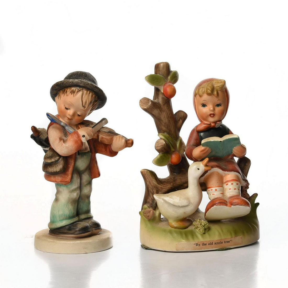 1 VINTAGE HUMMEL FIGURINE, 1 ARNART: Boy w. violin marked W. Germany; girl with goose signed. Girl-titled 'by the old apple tree'- signed by Erich Stauffer and marked with Arnart crossed arrows, S8395. Issued: c. 1960-1972 Dimensions: 5.