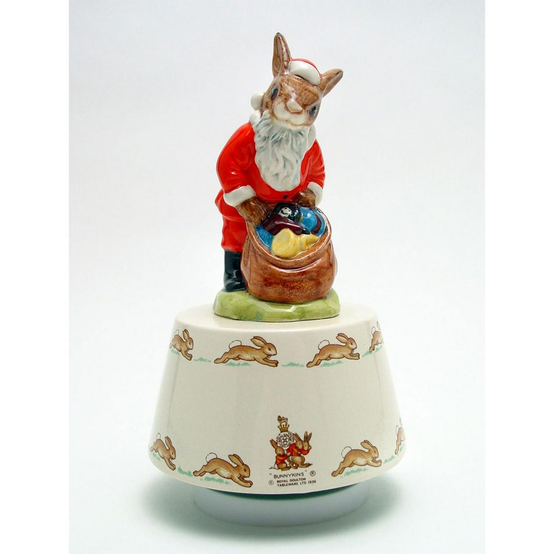 ROYAL DOULTON BUNNYKINS FIGURINE, WHITE CHRISTMAS MUSIC: Royal Doulton Bunnykins, Santa Claus Bunnykins Music Box DB34 (Red, white and brown coloration). Designed by Harry Sales, Issued 1984 - 1991. Size 7.25"H Artist: H. Sales Issued: 1984 - 1991 Dimension