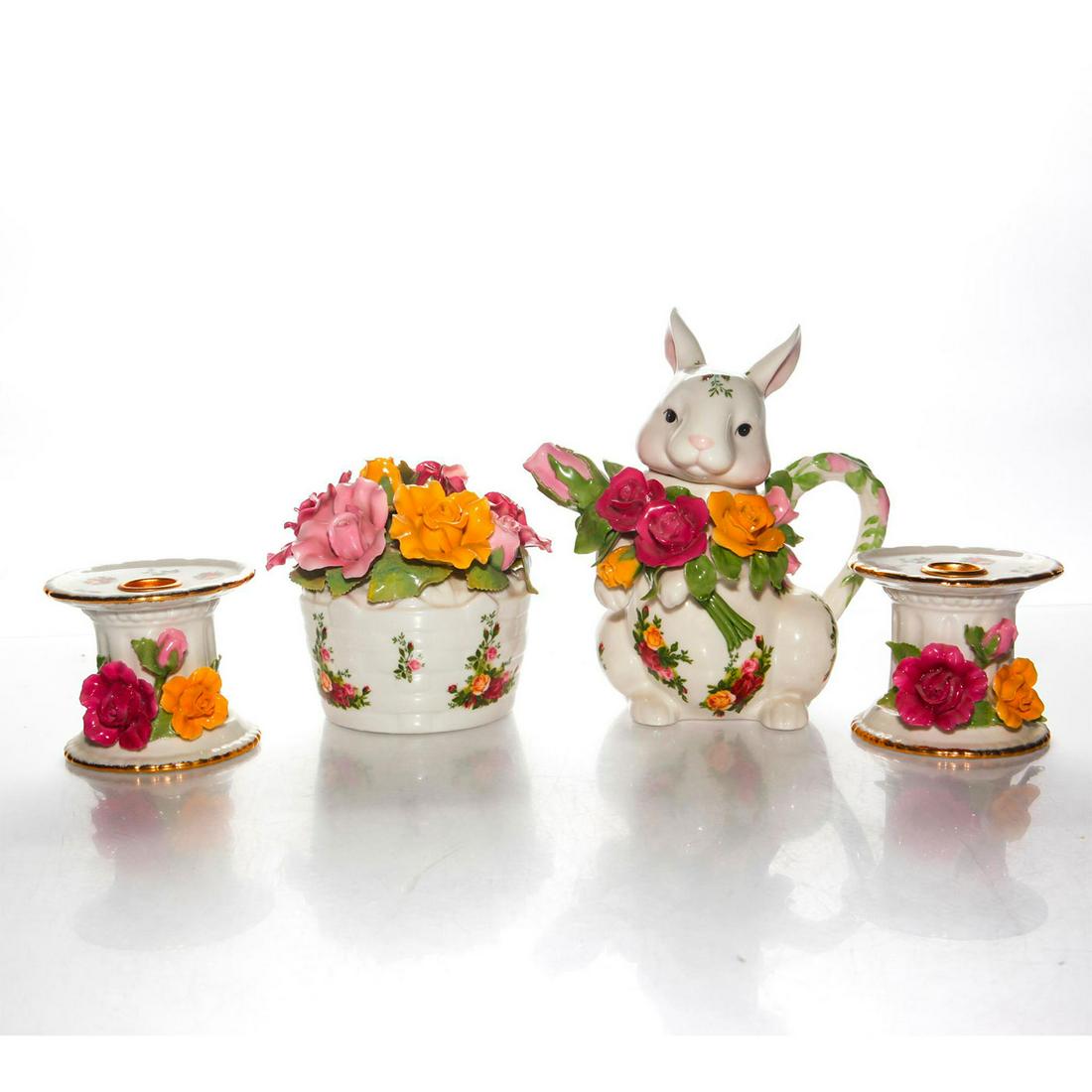 GROUP OF FOUR ROYAL ALBERT OLD COUNTRY ROSES CERAMICS: Glazed ceramic music box, rabbit teapot, and candleholders pair. An exemplary group of four Royal Albert Old Country Roses ceramics, based on the best-selling dinnerware pattern in the world. Launched