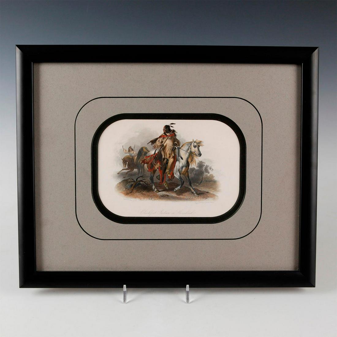 KARL BODMER BLACKFOOT INDIAN ON HORSEBACK PRINT: Black ornate framed print with engraved professional color. Print depicts Native American Indian riding on a galloping horse. The Blackfeet Indians were also known as Niitsitapi. Archival print from G