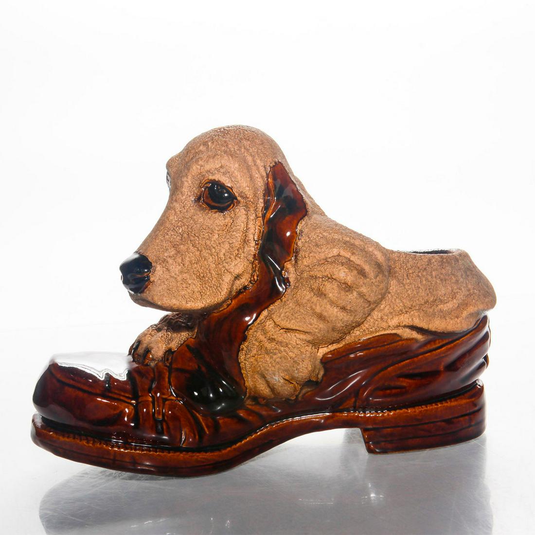 HAEGER MID CENTURY MODERN BASSET HOUND DOG PLANTER: Bennington glaze ceramic planter depicts dog in a man's loafer. Haeger backstamp. Issued: 20th c. Dimensions: 7.75"H x 11"L Country of Origin: United States