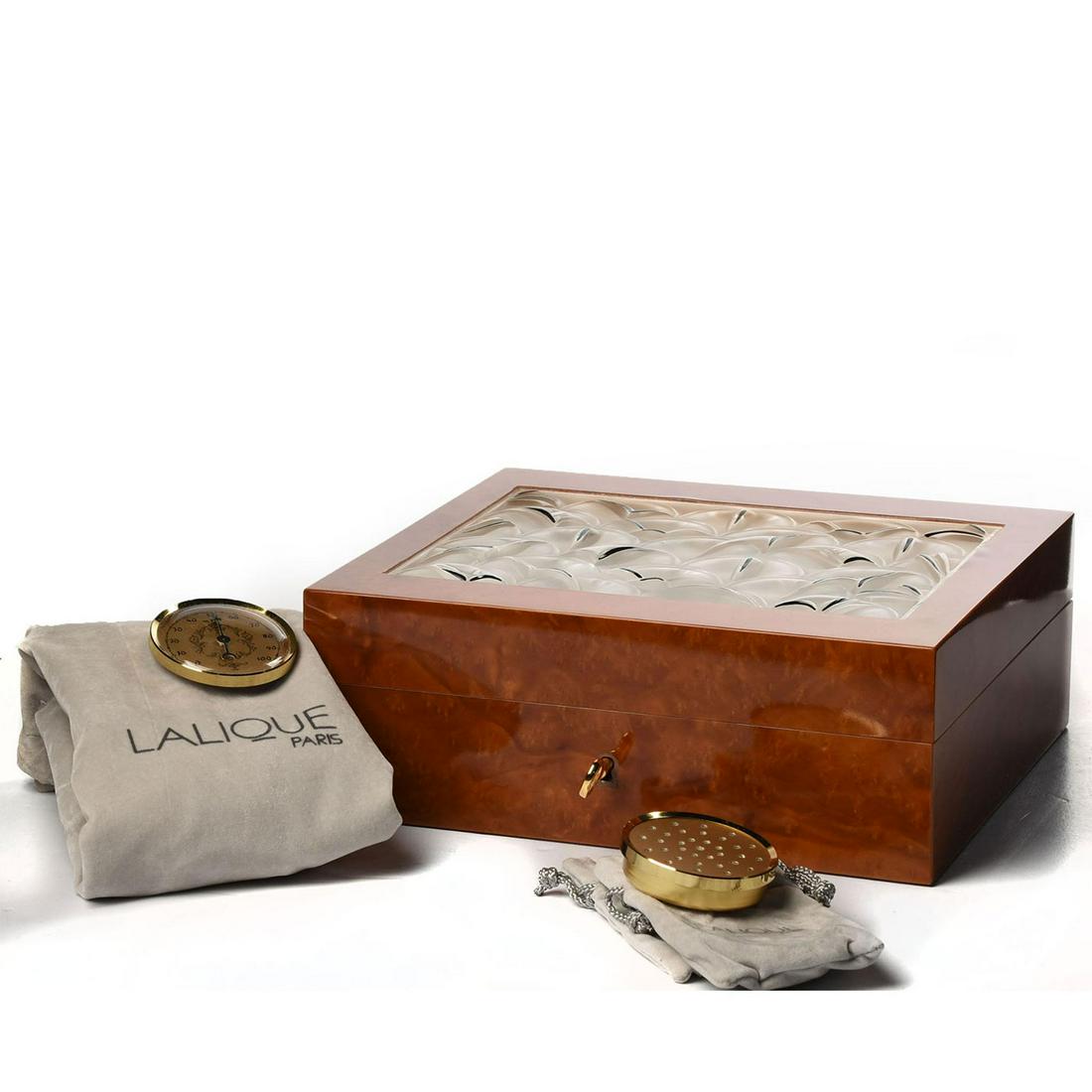 FRENCH LALIQUE CRYSTAL AND BURLWOOD CIGAR HUMIDOR: Lockable with key; art glass top. In box with bag, barometer. The original gold tone barometer and humidor sponge holder can be mounted as it pleases the owner. Solid wood construction, and gold-tone 