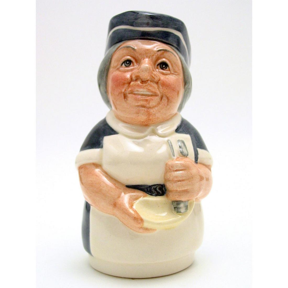 MISS NOSTRUM THE NURSE D6700 - ROYAL DOULTON TOBY JUG: Royal Doulton Toby Jug, Miss Nostrum the Nurse D6700 (blue uniform; white apron; blue and white cap). Designed by William K. Harper. Series: The Doultonville Collection, issued 1983 - 1991. Size: 4''H