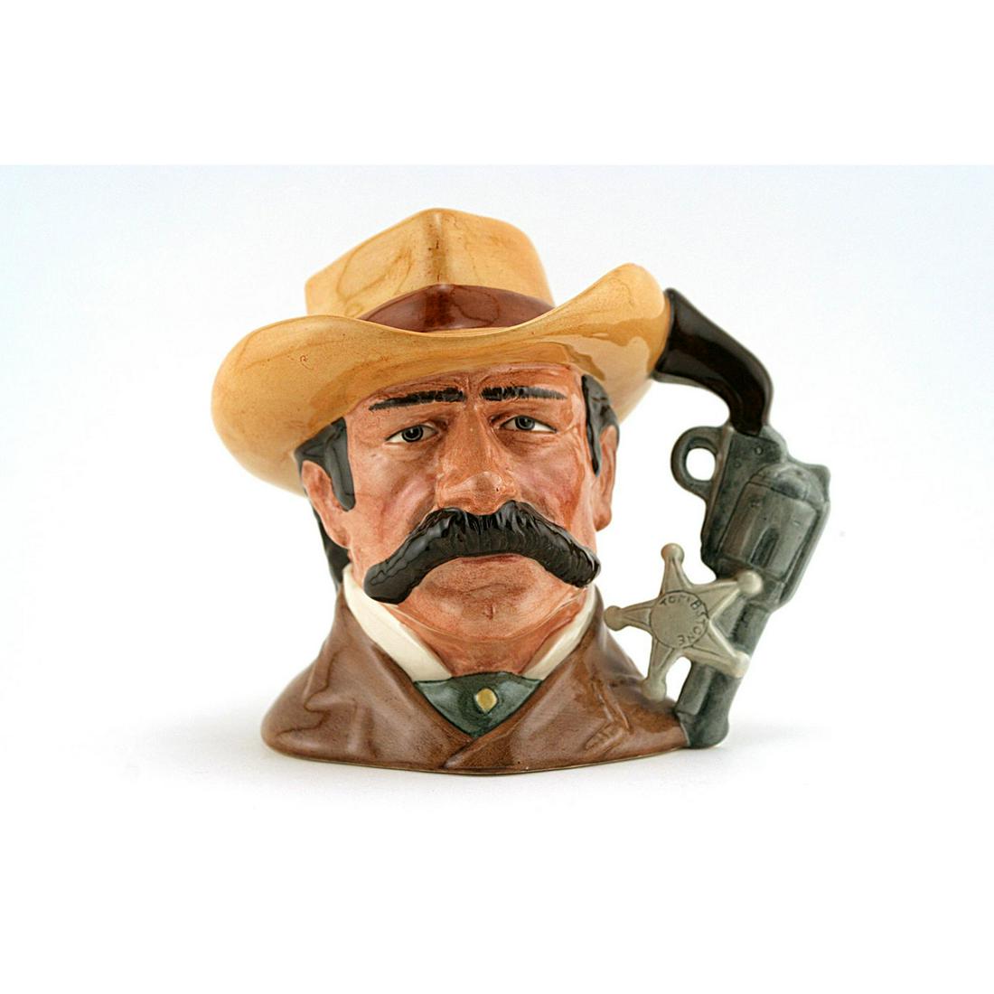 WYATT EARP D6711 - ODD SIZE - ROYAL DOULTON CHARACTER: Royal Doulton Character Jug, Wyatt Earp D6711 (brown coat; light brown hat with red band). Designed by Stanley J. Taylor. Series: The Wild West Collection, issued 1985 - 1989. Size: 5.5"H (odd)Wyatt B
