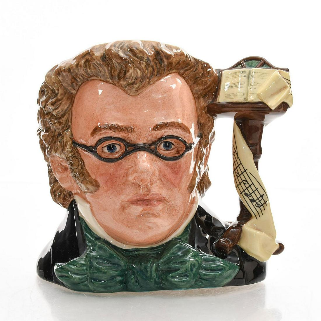 SCHUBERT D7056 - LARGE - ROYAL DOULTON CHARACTER JUG: Royal Doulton Character Jug, Schubert D7056 (black, green, brown and yellow coloration). Designed by Stanley J. Taylor. Series: Great Composers, issued 1997 - 2001. Size: 6.75"H (Large)Franz Schubert 