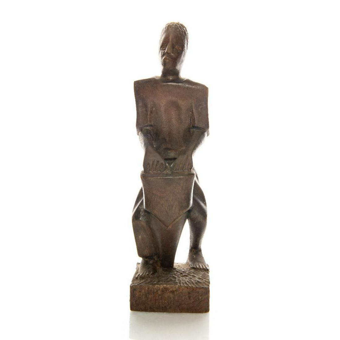 VINTAGE AFRICAN WOODEN FIGURINE, NATIVE MUSICIAN: Handcarved tribal figurine depicts man playing a bongo drum. Traditional musician folk art model. Issued: 20th c. Dimensions: 9.75"H
