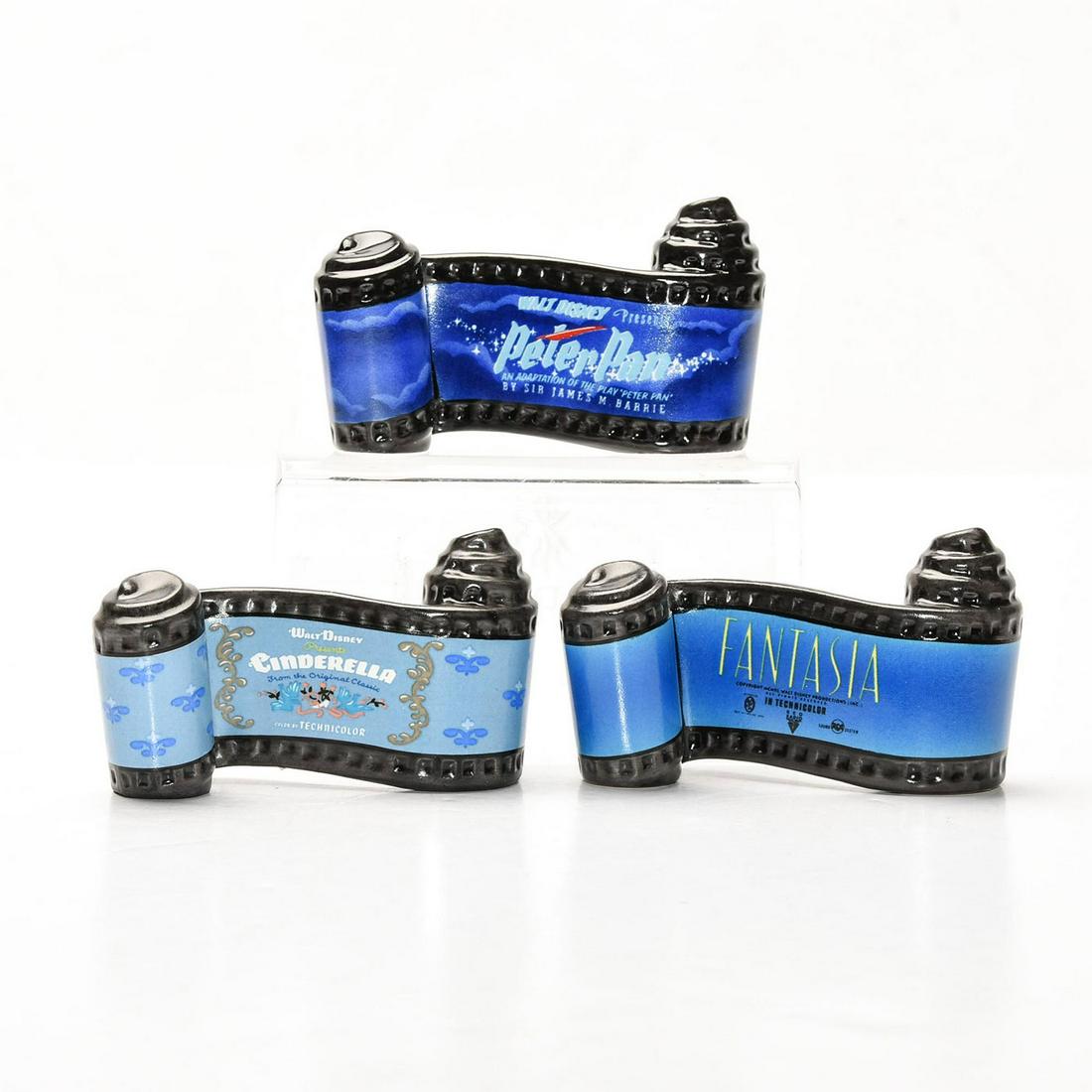 THREE DISNEY CLASSICS OPENING TITLE SCROLL FIGURINES: CINDERELLA, PETER PAN and FANTASIA. DISNEY backstamp. Stamped to sides WALT DISNEY CLASSICS COLLECTION. Certificate of Authenticity. Collectors box. Issued: c. 1995 Dimensions: 3.5"L Manufacturer: Wal