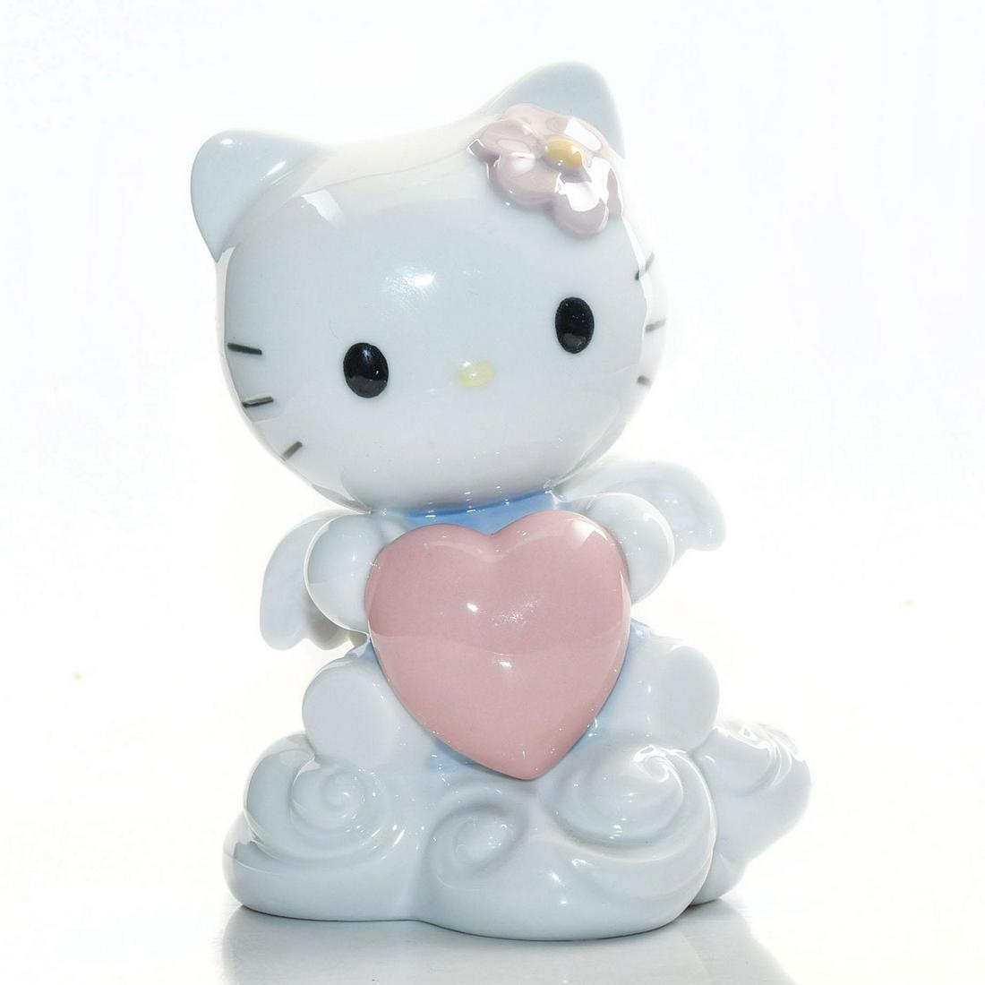NAO HANDMADE PORCELAIN, FROM THE HEART HELLO KITTY: Spanish figurine of iconic Japanese character, with heart, wings. Issued: 2011 Dimensions: 5.25"H Manufacturer: Nao Country of Origin: Spain