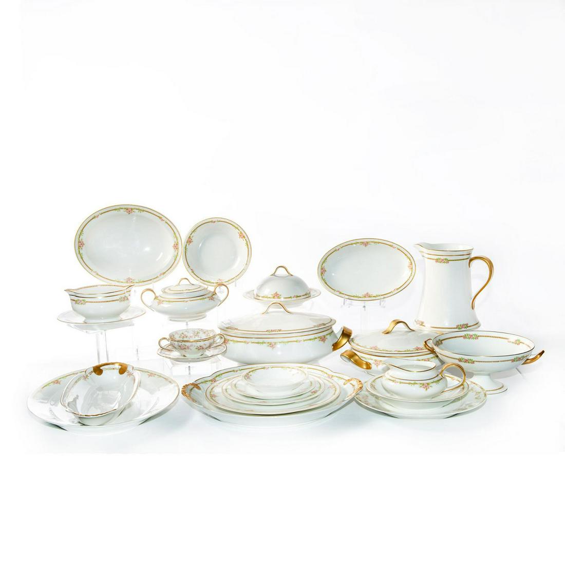 94 PC THEODORE HAVILAND DINING ROOM SET: An impressive dinnerware set. Floral design with gilt accents. Includes plates, gravy boats, cups, serving bowls and chafing dish. Theodore Haviland backstamps. Issued: 20th c. Dimensions: 14"L x 12.5