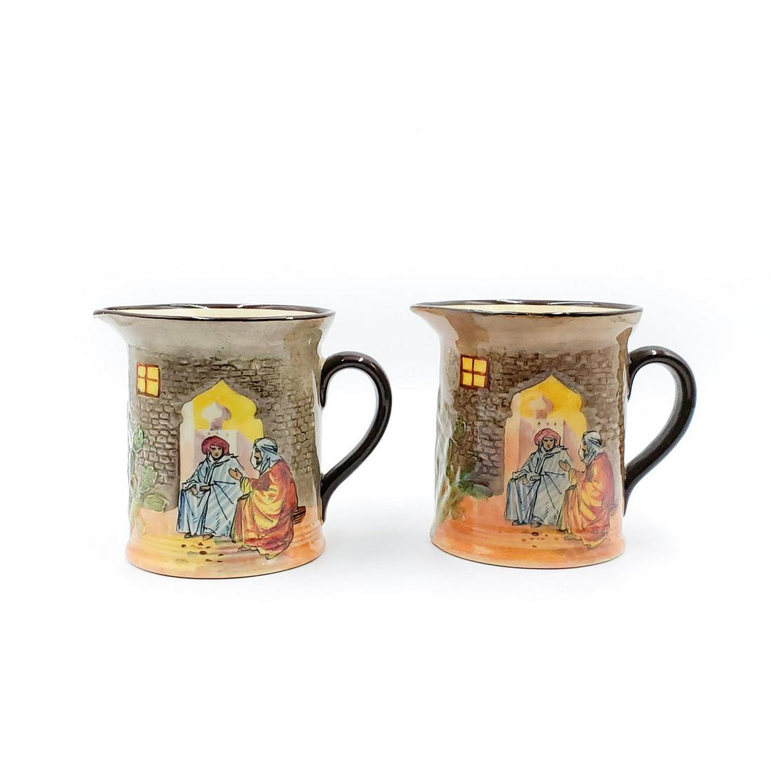 2 ROYAL DOULTON ARABIAN NIGHTS JUGS: Ceramic jugs with Arabic scenes encircling body. Doulton backstamp. Issued: 20th c. Dimensions: 4"H, each Manufacturer: Royal Doulton Country of Origin: England