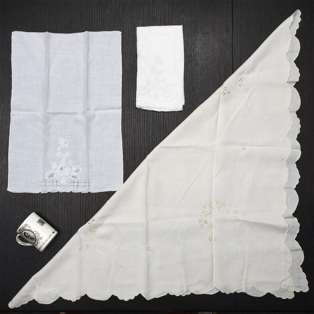 MADEIRA FINE LINENS, 2 TEA NAPKINS W. TEA TABLE CLOTH: Ivory color, with raised floral embroidery, rondels, and cutwork. Some stains present. Napkins measure 20"L x 14"W. Issued: 20th c. Dimensions: 35"L x 34"W, tablecloth