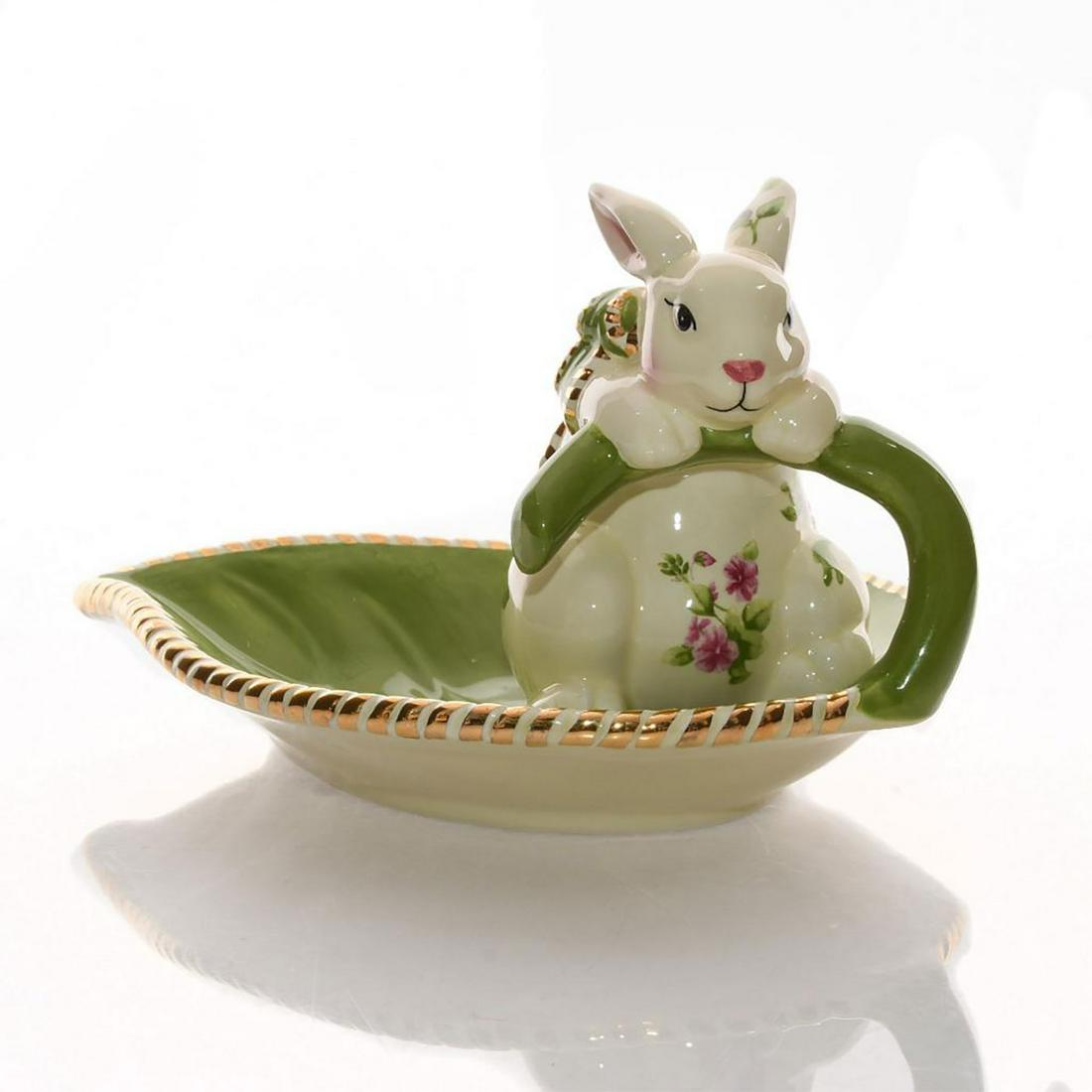 ROYAL ALBERT SEASONS OF COLOUR BUNNY CANDY DISH: Old Country Roses pattern. Features bunny on a leaf. Green and white colorway with gilt accents. Complete with box. Issued: 20th c. Dimensions: 4.75"H x 8"L Manufacturer: Royal Albert Country of Origi