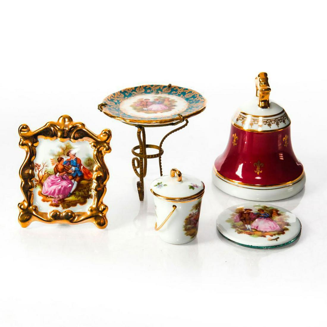 5 LIMOGES PORCELAIN MINIATURES: 4 pieces featuring romantic scenes, 1 fleur-de-lys bell. Each stamped Limoges. Mirror to underside of circular miniature shows age related wear. Issued: 20th c. Dimensions: 3.5"H, tallest Country of O