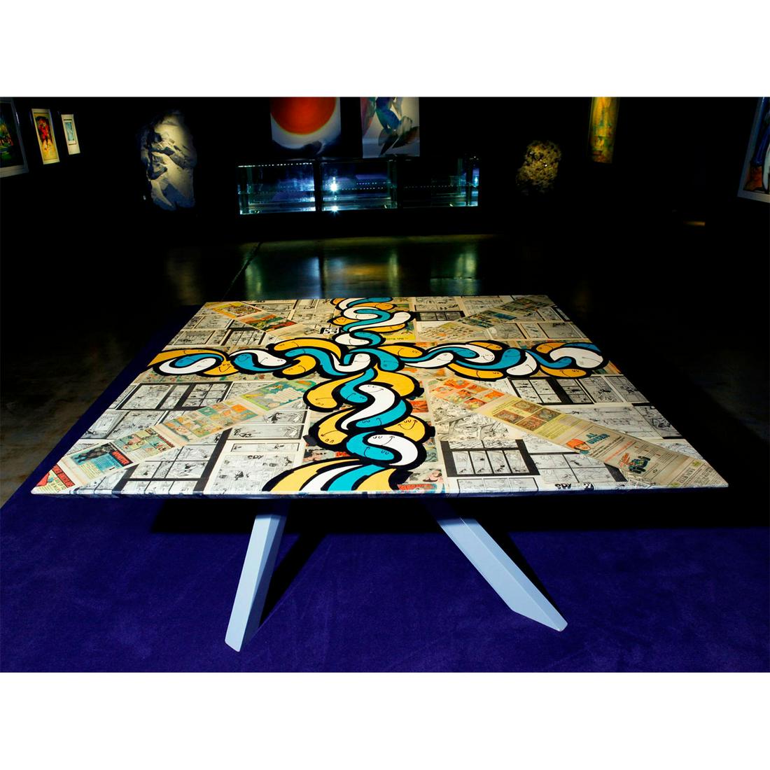 DAVID LE BATARD, ORIGINAL MIXED FINE ART DINING TABLE: One of a kind design; reclaimed news and comic pieces, varnished. David Le Batard, known in the art world as Lebo is a Cuban-American artist inspired by ancient modes of storytelling, comic strip comp
