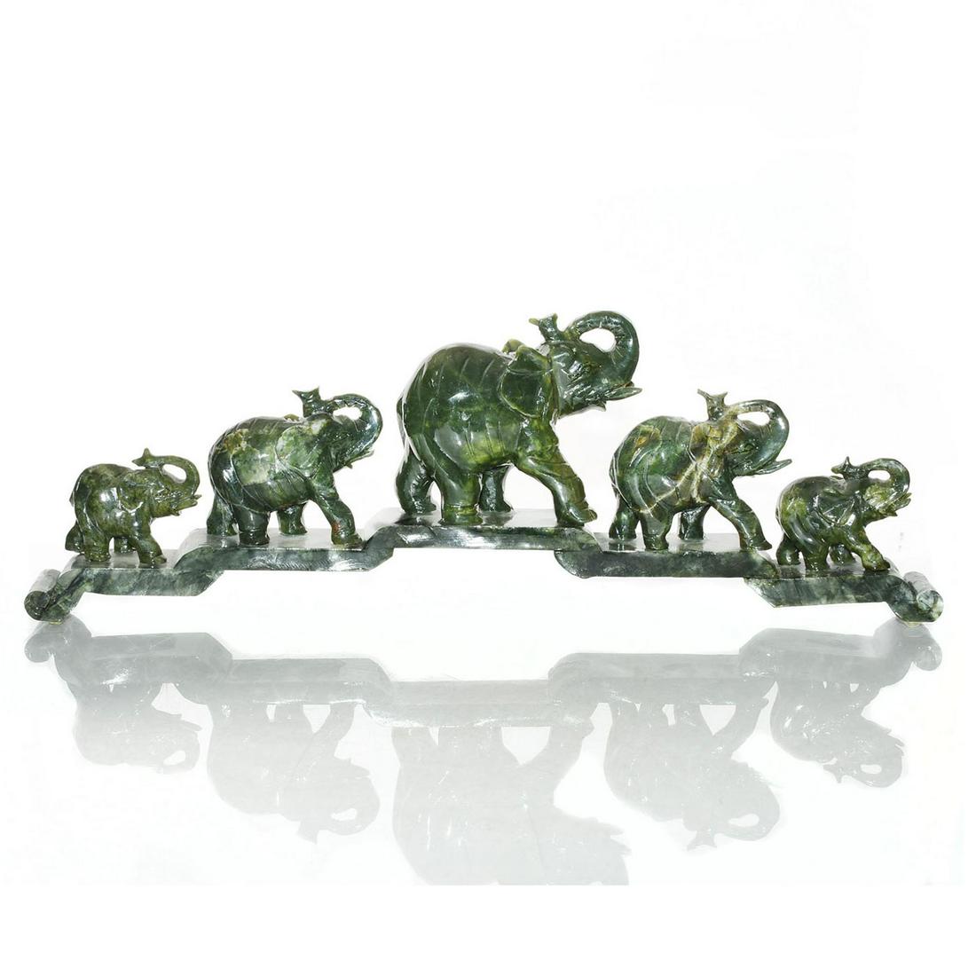 CHINESE DARK GREEN CARVED JADE ELEPHANT FIGURAL GROUP: 5 elephants with upraised trunks on base. Dark green, inclusions. Finely carved dark green Chinese jade, with russet and white inclusions. Five elephants, symbols of silent power, majesty, kindness an