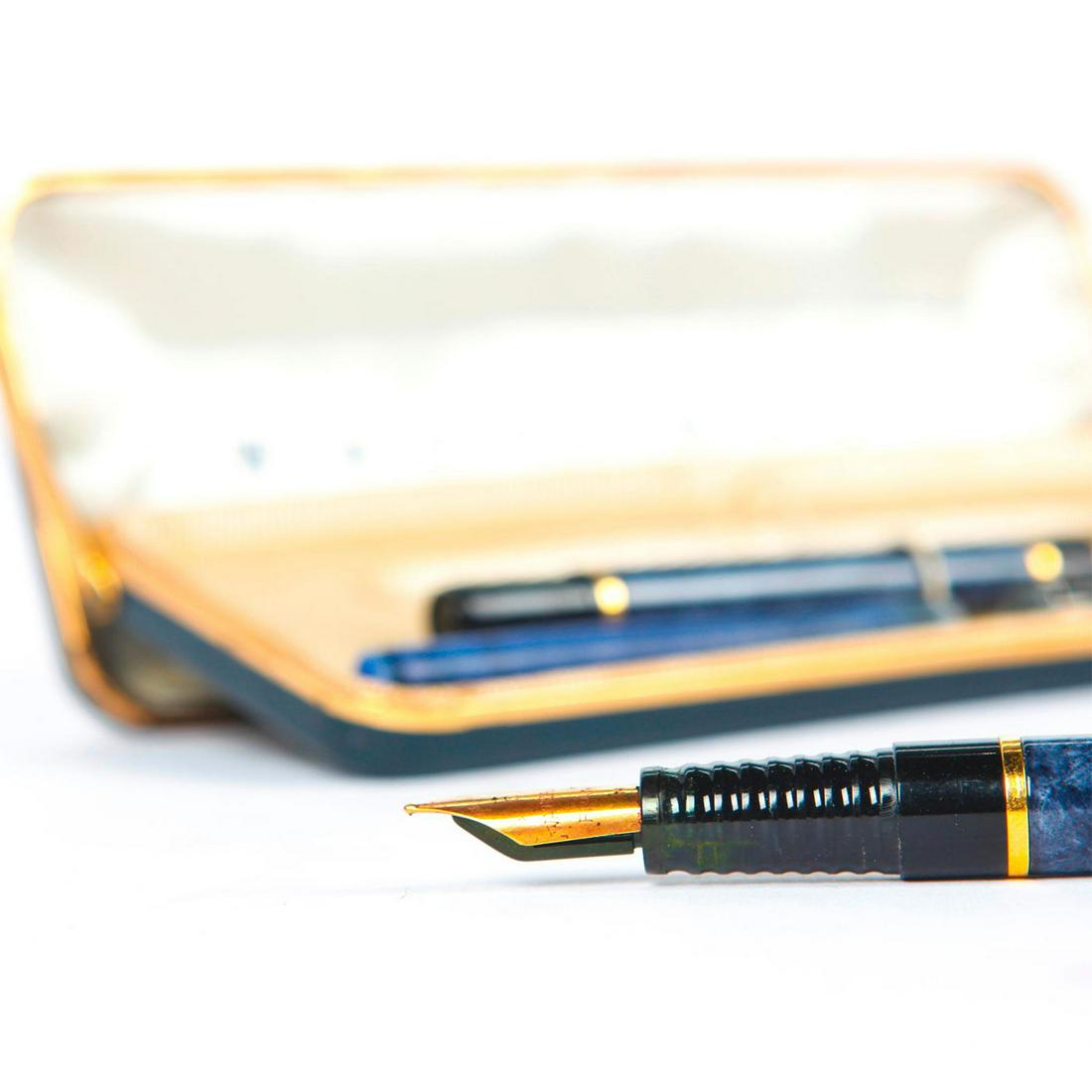 WATERMAN 2 PEN SET, FOUNTAIN AND BALL POINT: Blue and black with gold plated detail, original case. Plastic tip of ballpoint pen is broken. Issued: 20th c. Dimensions: 5.25"L, longest pen Manufacturer: Waterman Country of Origin: France