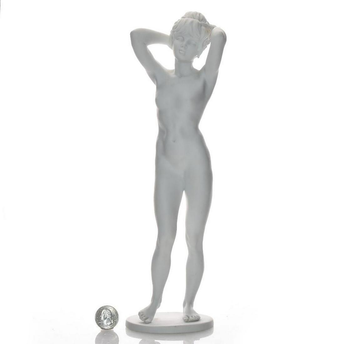 KAISER PORCELAIN FIGURINE, NUDE WOMAN STANDING: White porcelain; matte finish. Signed by artist on base. Kaiser backstamp. Issued: 20th c. Dimensions: 13"H Country of Origin: West Germany Provenance: David Farin Collection