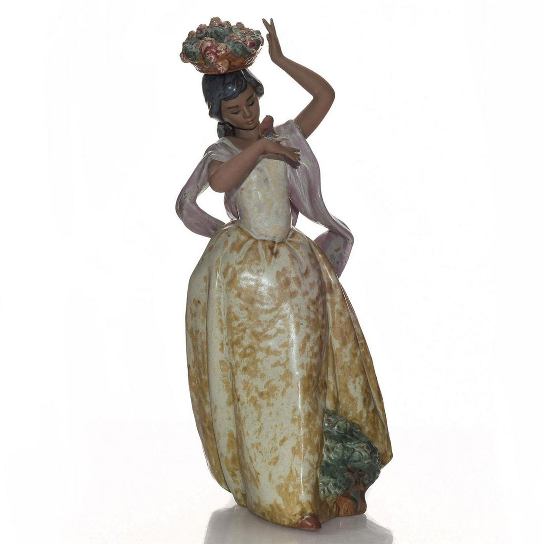 LLADRO FIGURINE, A BIRD ON HAND 01012151: Stoneware; gres or matte finish. Woman with bird on her hand. Lladro stamp on the underside. Artist: Regino Torrijos Issued: 1985-1999 Dimensions: 11.75"H Manufacturer: Lladro Country of Origin: Spain