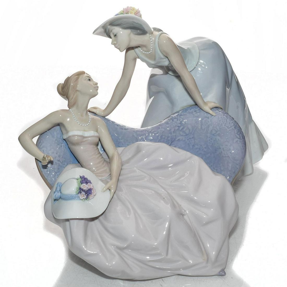 LLADRO FIGURINE, DEBUTANTES 01005486: Features 2 upper class young ladies enjoying a party. Porcelain; glazed finish. Lladro backstamp. Includes box. Wear to box. Artist: Jose Puche Issued: 1988-1997 Dimensions: 8.25"H Manufacturer: Lladr