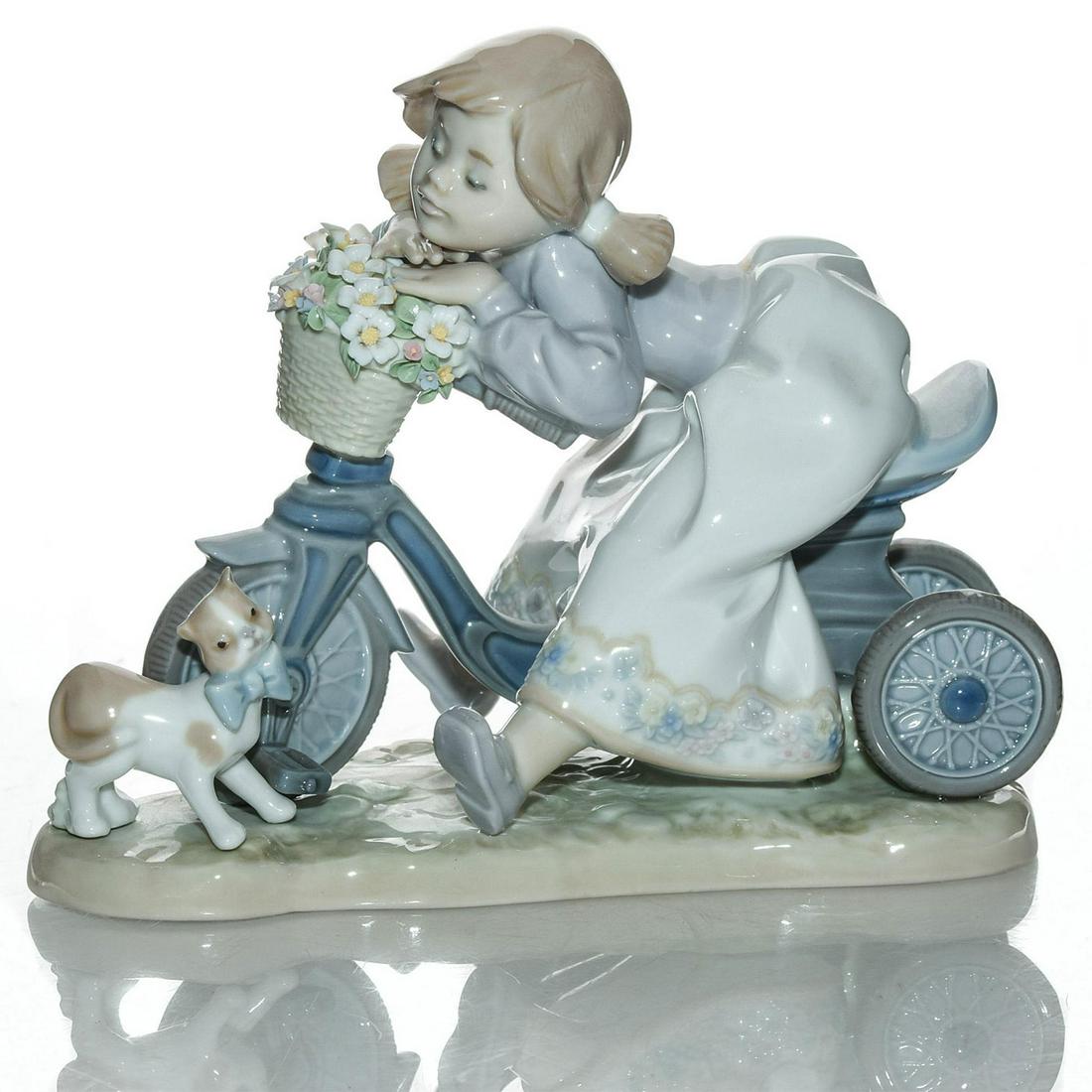 LLADRO FIGURINE, IN NO HURRY 01005679: Depicts girl on bike waiting for kitten to cross the street. Porcelain; glazed. Lladro backstamp. Includes box. Artist: Francisco Polope Issued: 1990-1994 Dimensions: 6"H Manufacturer: Lladro Country 