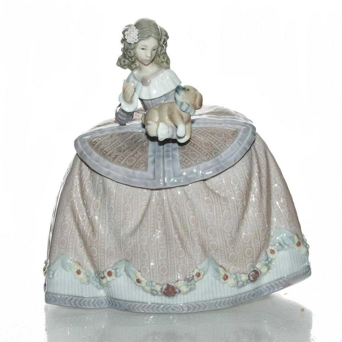 LLADRO LADY FIGURINE, PILAR 01005410: Young woman holding a puppy. Porcelain; glazed. Lladro backstamp. Exquisite details to floral design on woman's gown. Artist: Jose Puche Issued: 1987-1989 Dimensions: 6"H Manufacturer: Lladro Country 